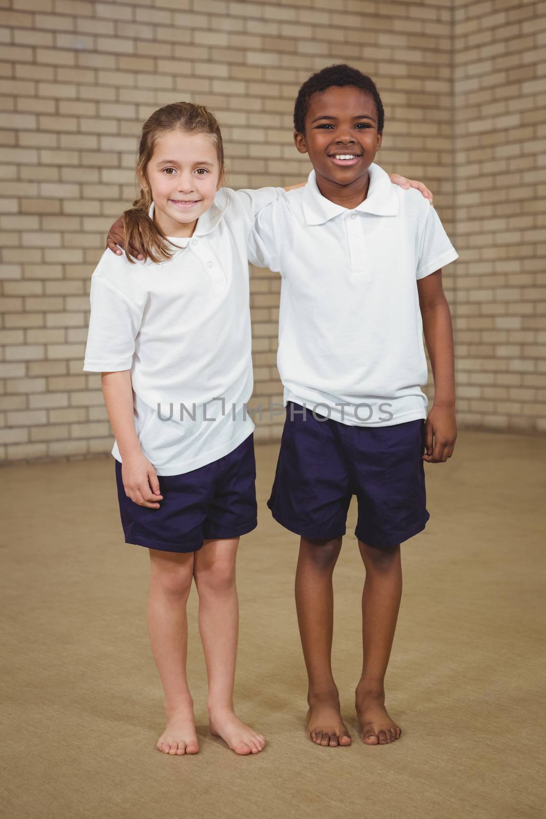 Pupils smiling with arms around each other at the elementary school