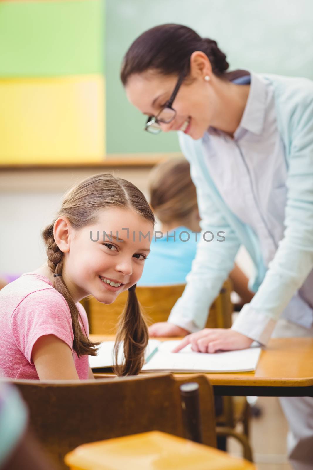 Teacher helping a pupil during class at the elementary school