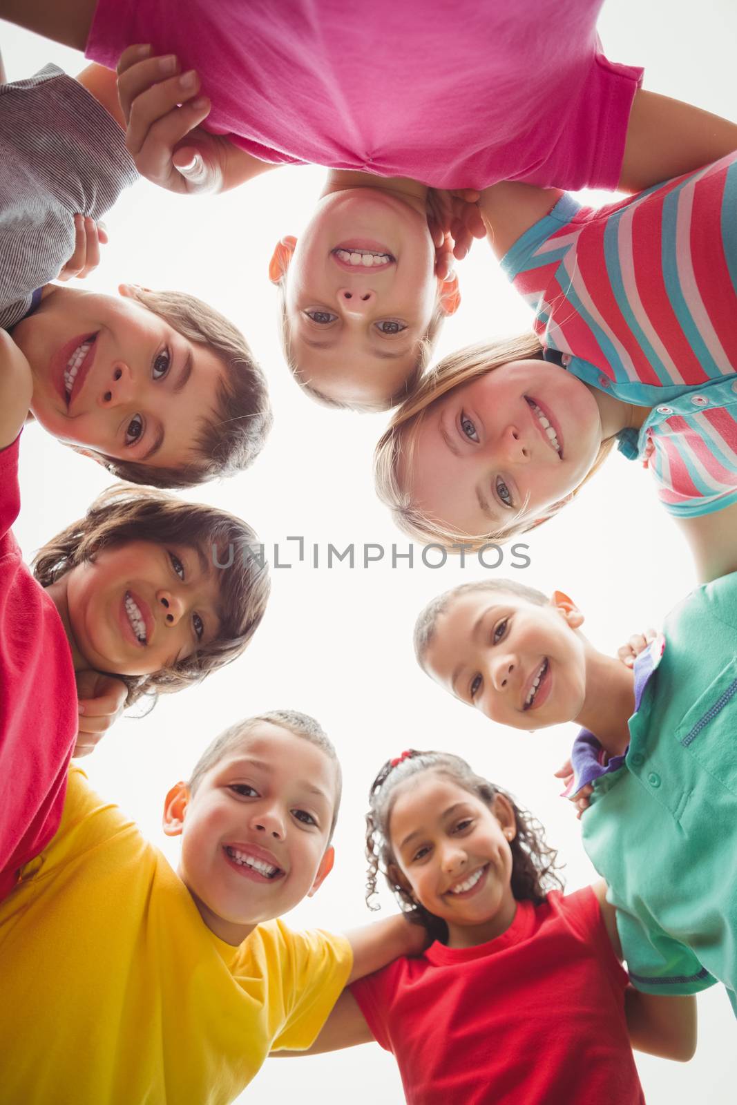 Cute pupils in a huddle  by Wavebreakmedia