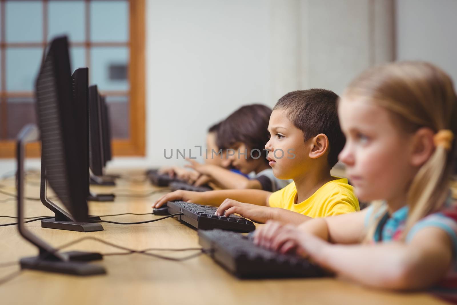 Cute pupils in computer class at the elementary school