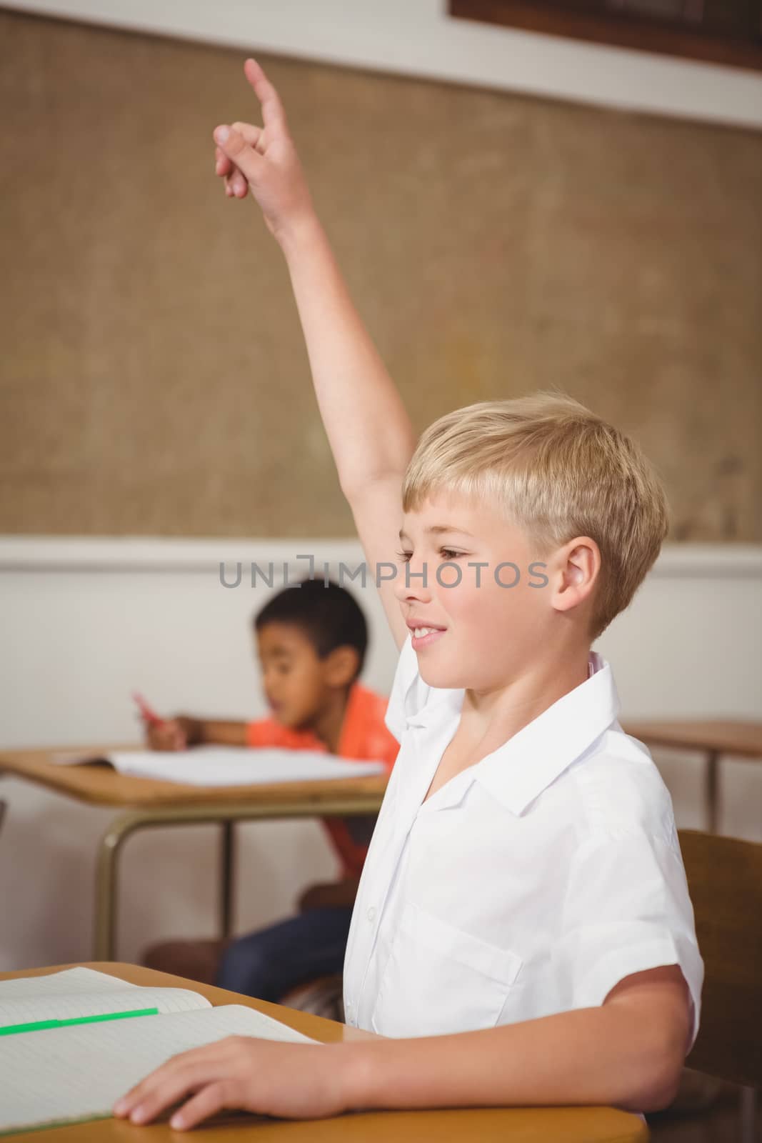 Student raising hand to ask question at the elementary school