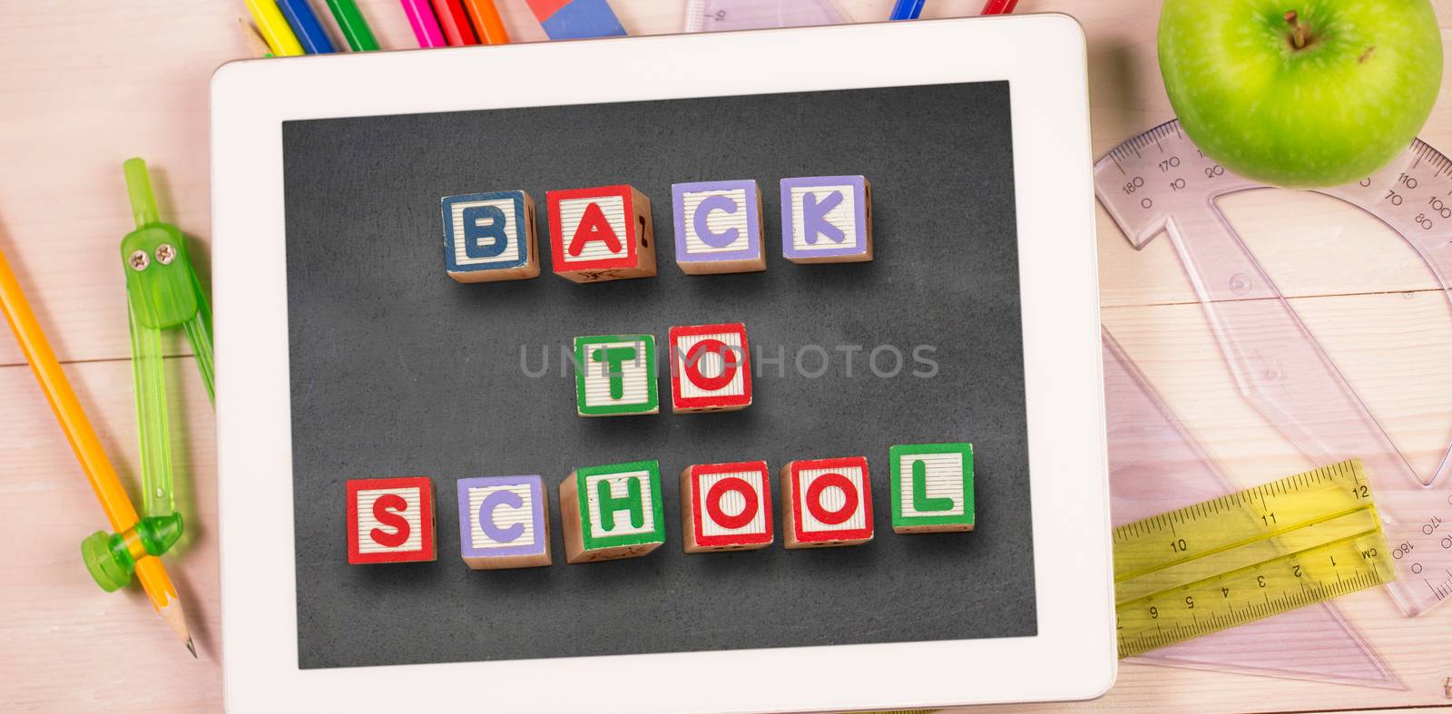 Back to school message against students desk with tablet pc