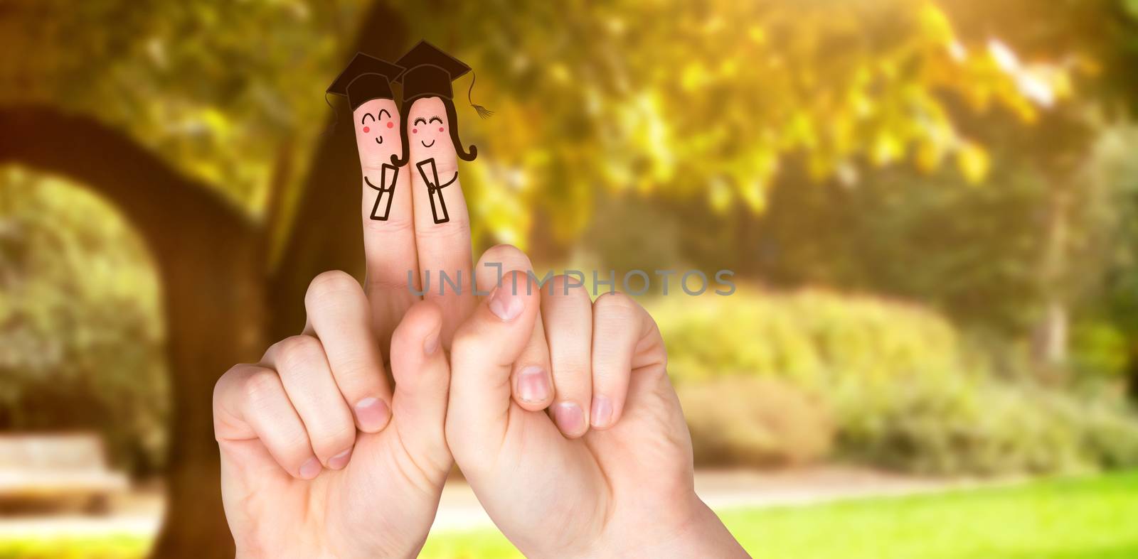 Fingers posed as students against trees and meadow in the park