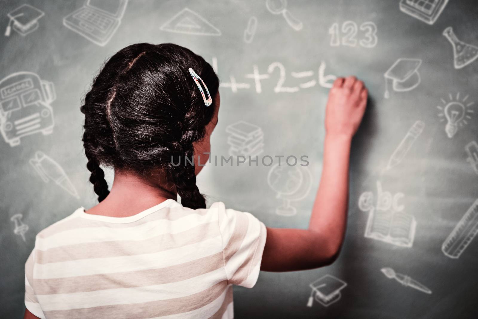 Education doodles against rear view of little girl writing on blackboard