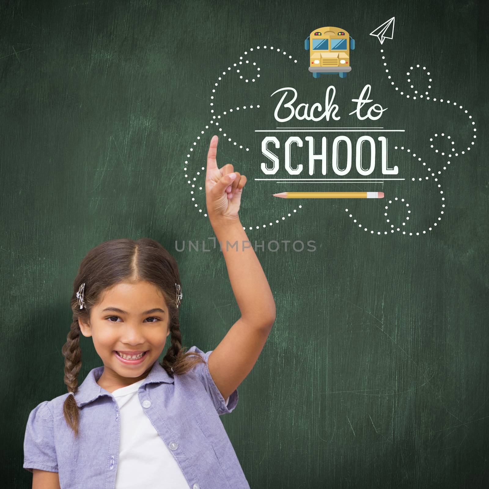 Happy pupil with arm raised against green chalkboard