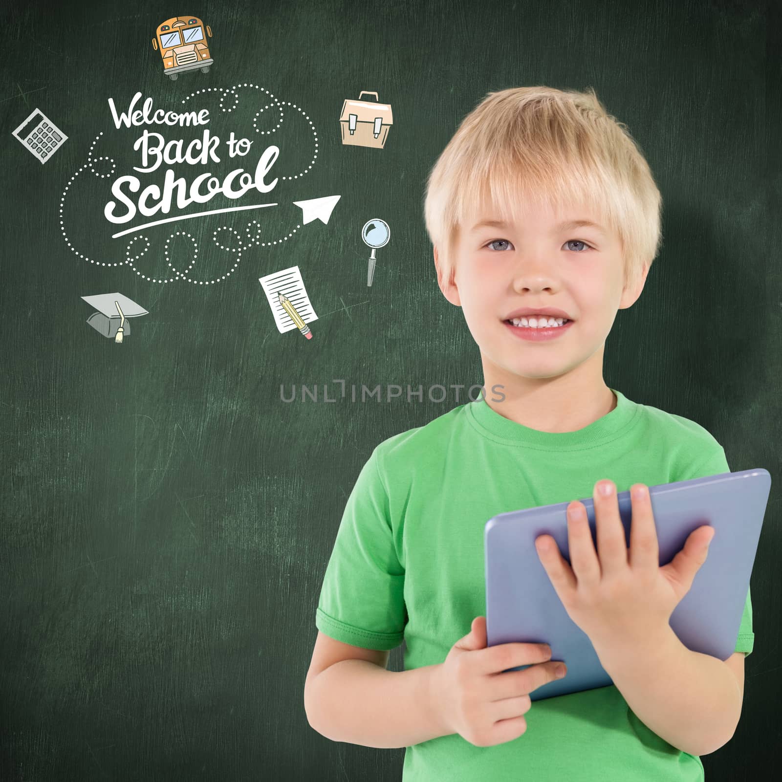 Cute boy using tablet against green chalkboard