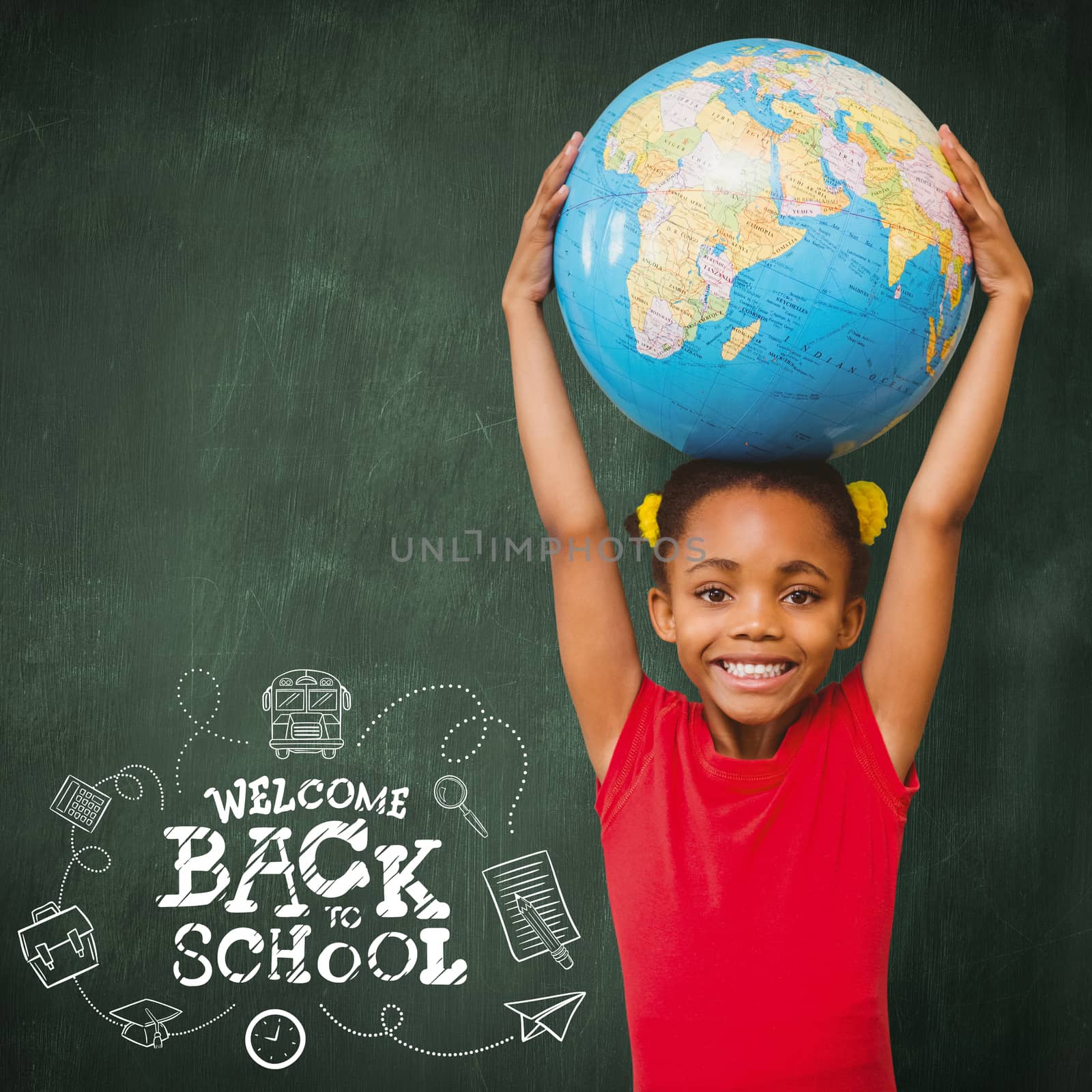 Pupil holding globe against green chalkboard