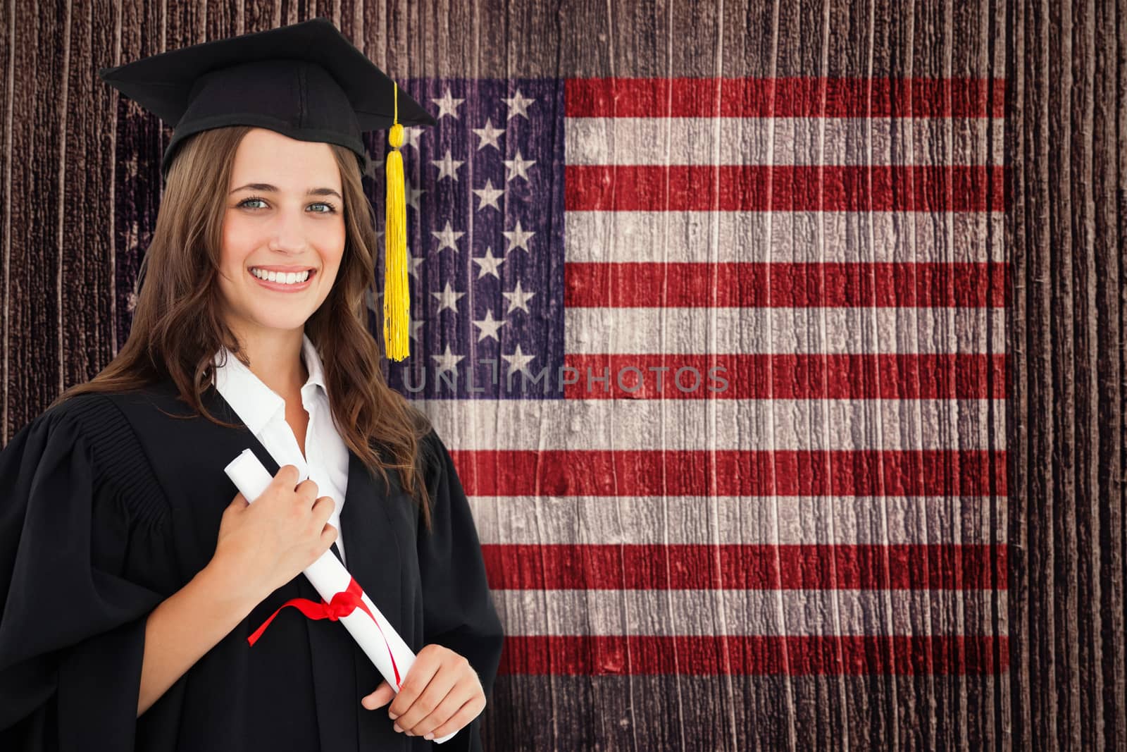 Composite image of a smiling woman with a degree in hand as she looks at the camera by Wavebreakmedia