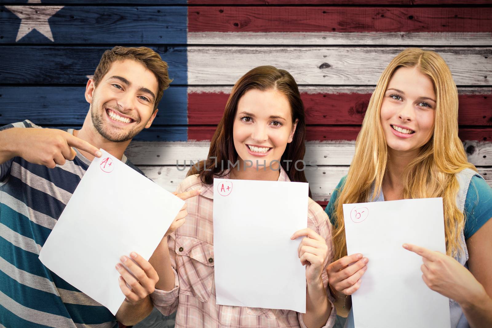 Smiling students showing their exams against composite image of usa national flag
