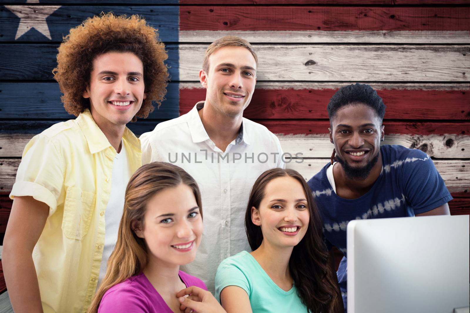 Smiling students in computer class against composite image of usa national flag