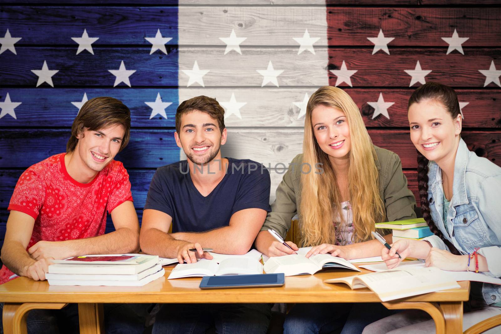 Students studying against composite image of usa national flag