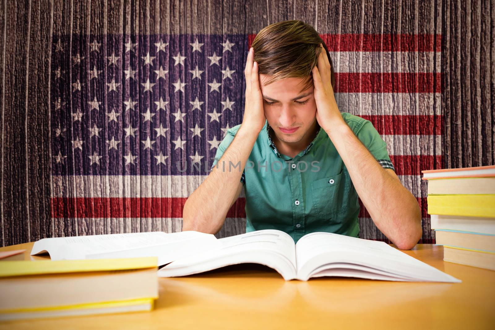 Student sitting in library reading  against composite image of usa national flag