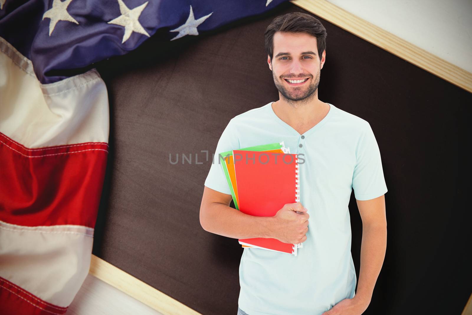 Composite image of student holding notepad by Wavebreakmedia