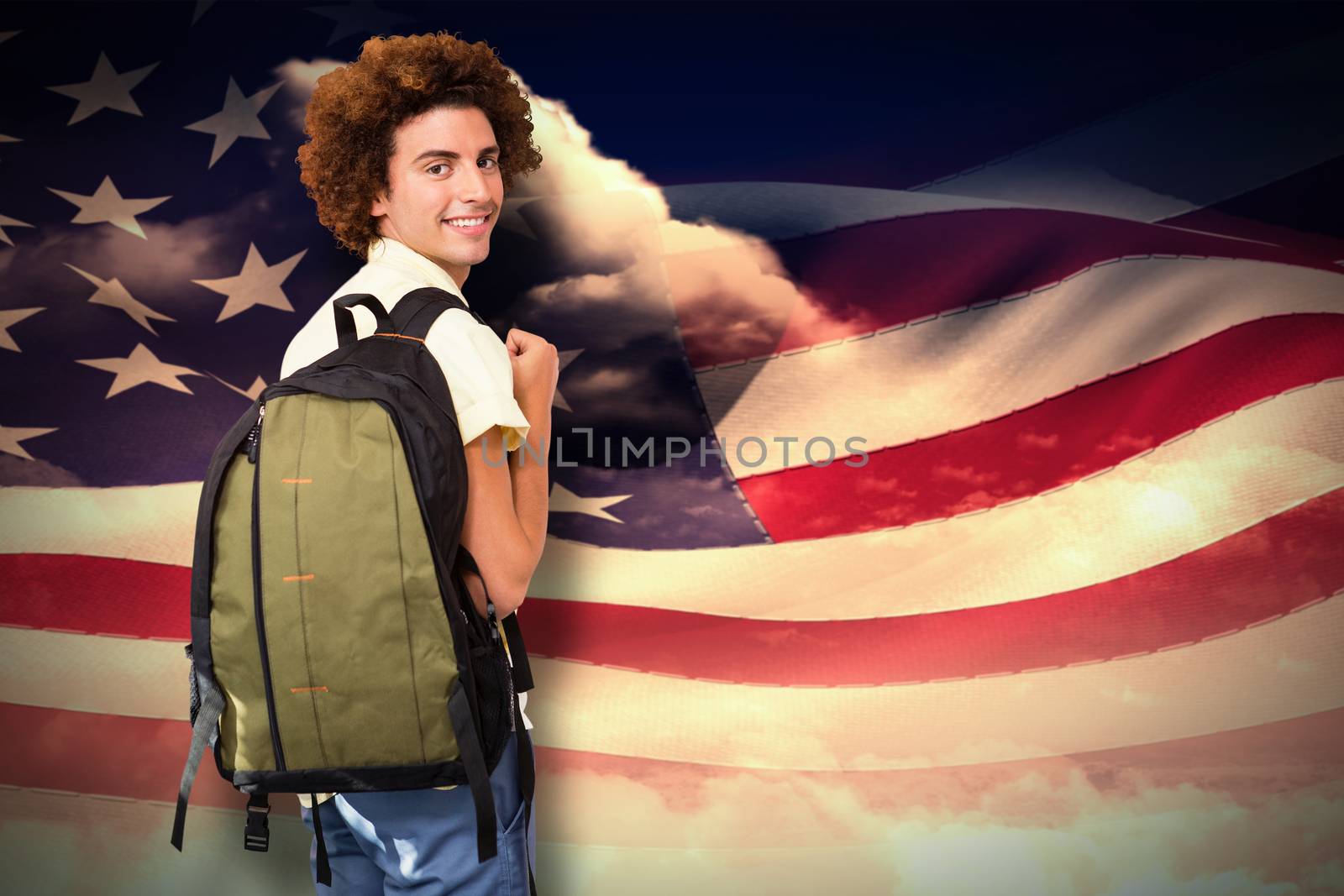 Casual young man in office corridor against composite image of digitally generated american flag rippling