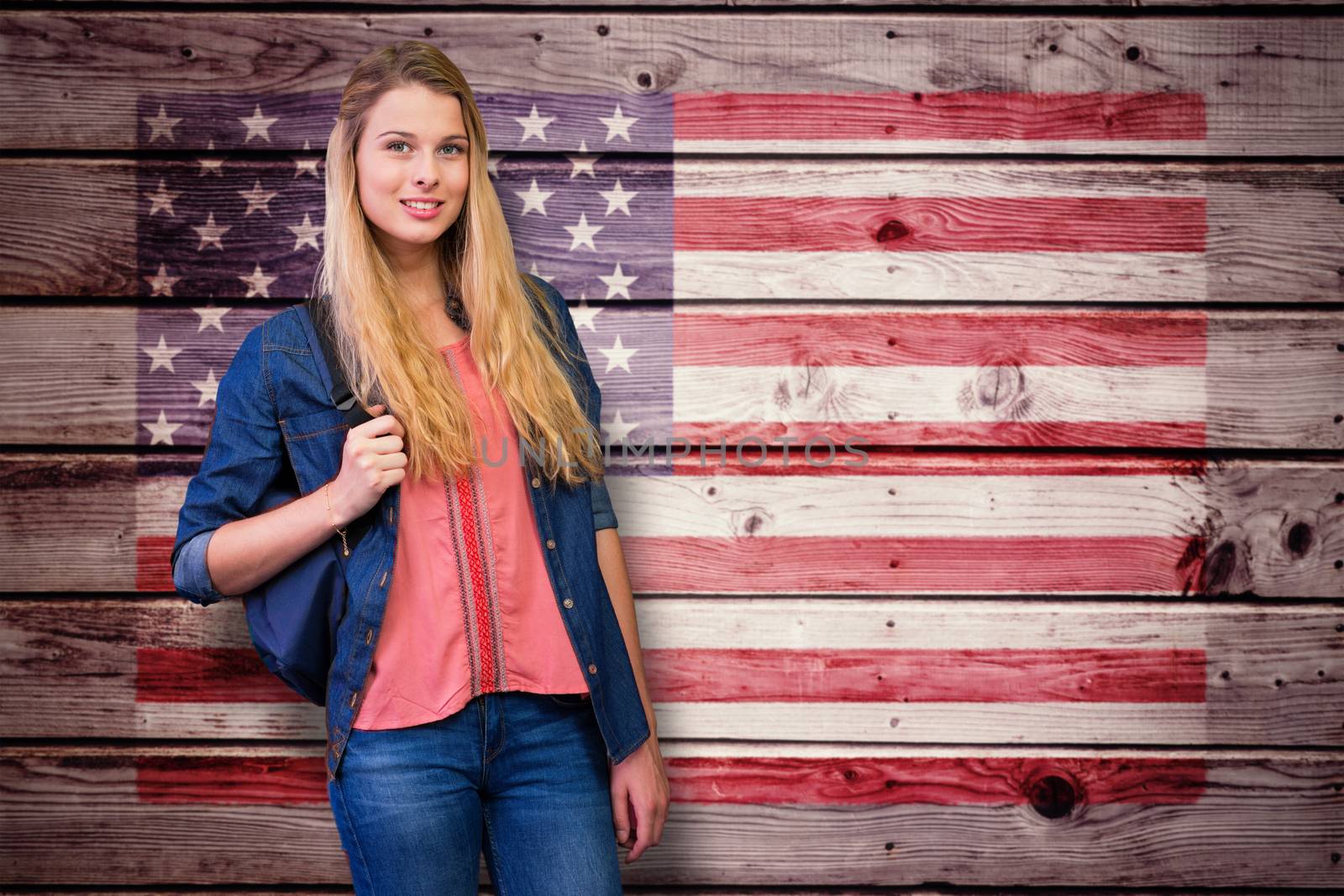 Pretty student in the library against composite image of usa national flag