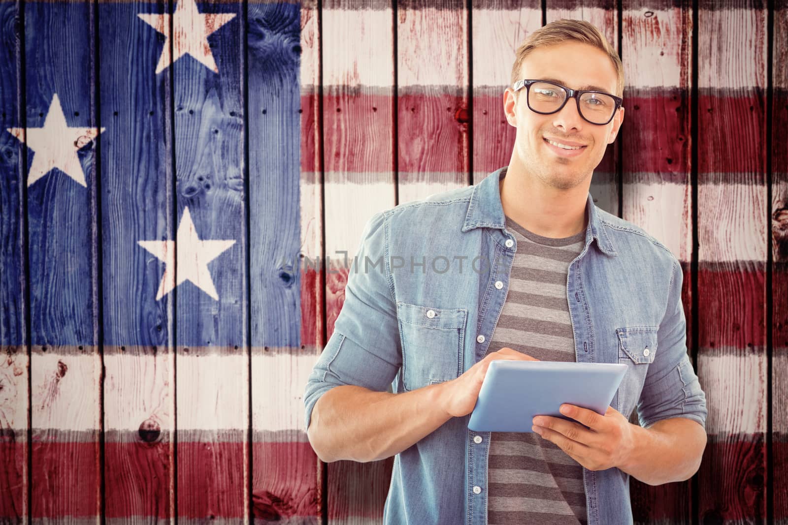 Student using tablet against composite image of usa national flag