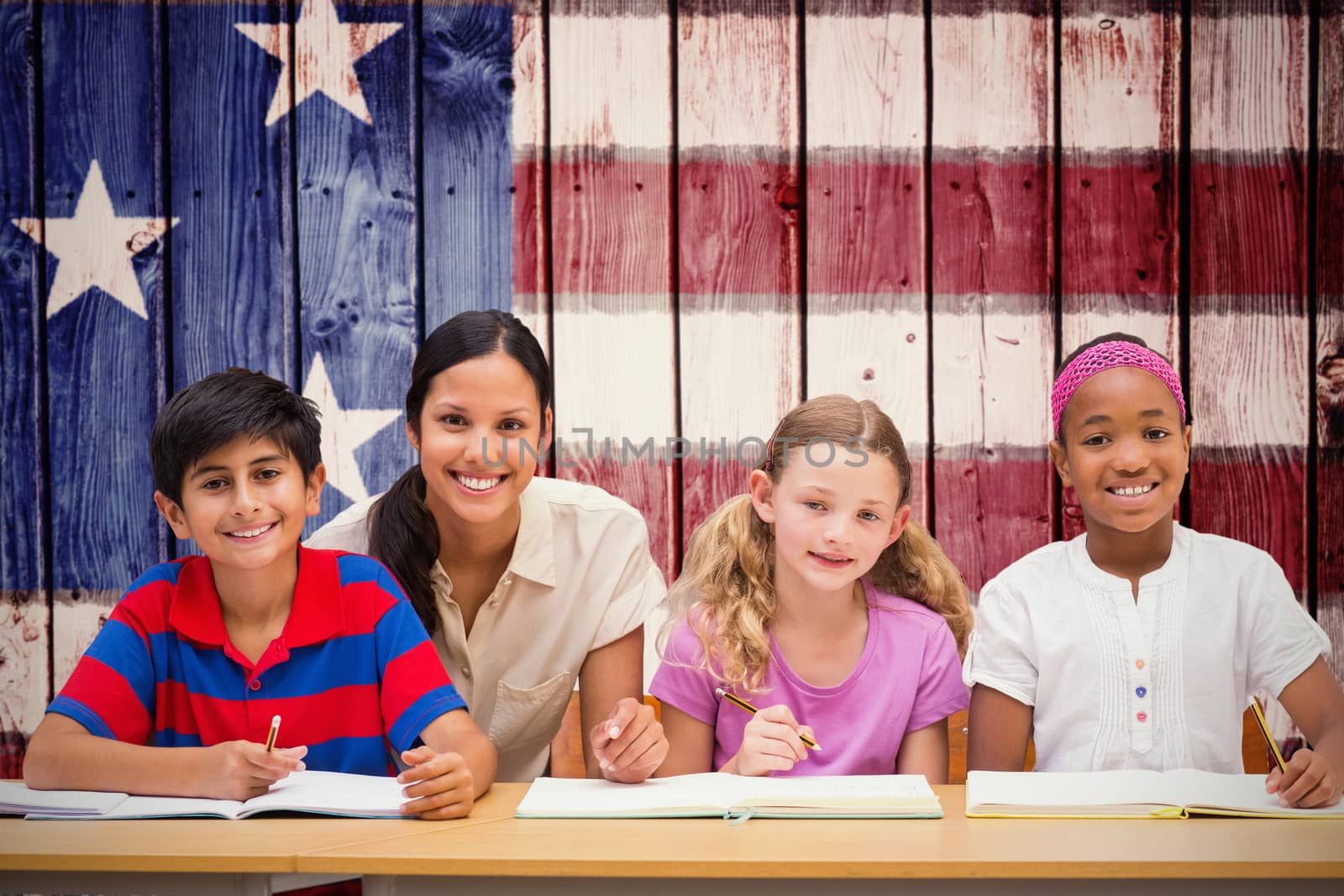 Pretty teacher helping pupils in library against composite image of usa national flag