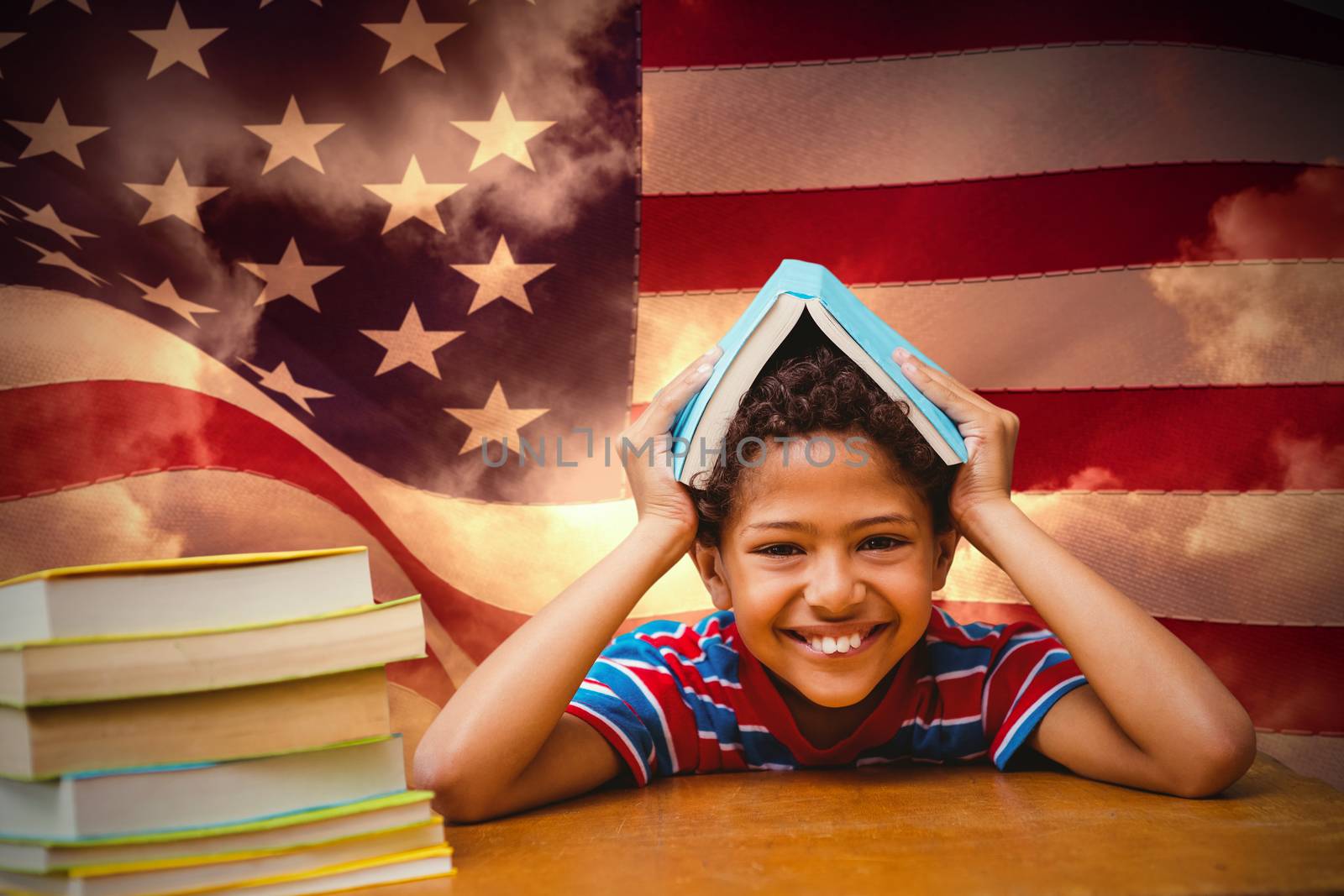 Pupil with many books against composite image of digitally generated united states national flag