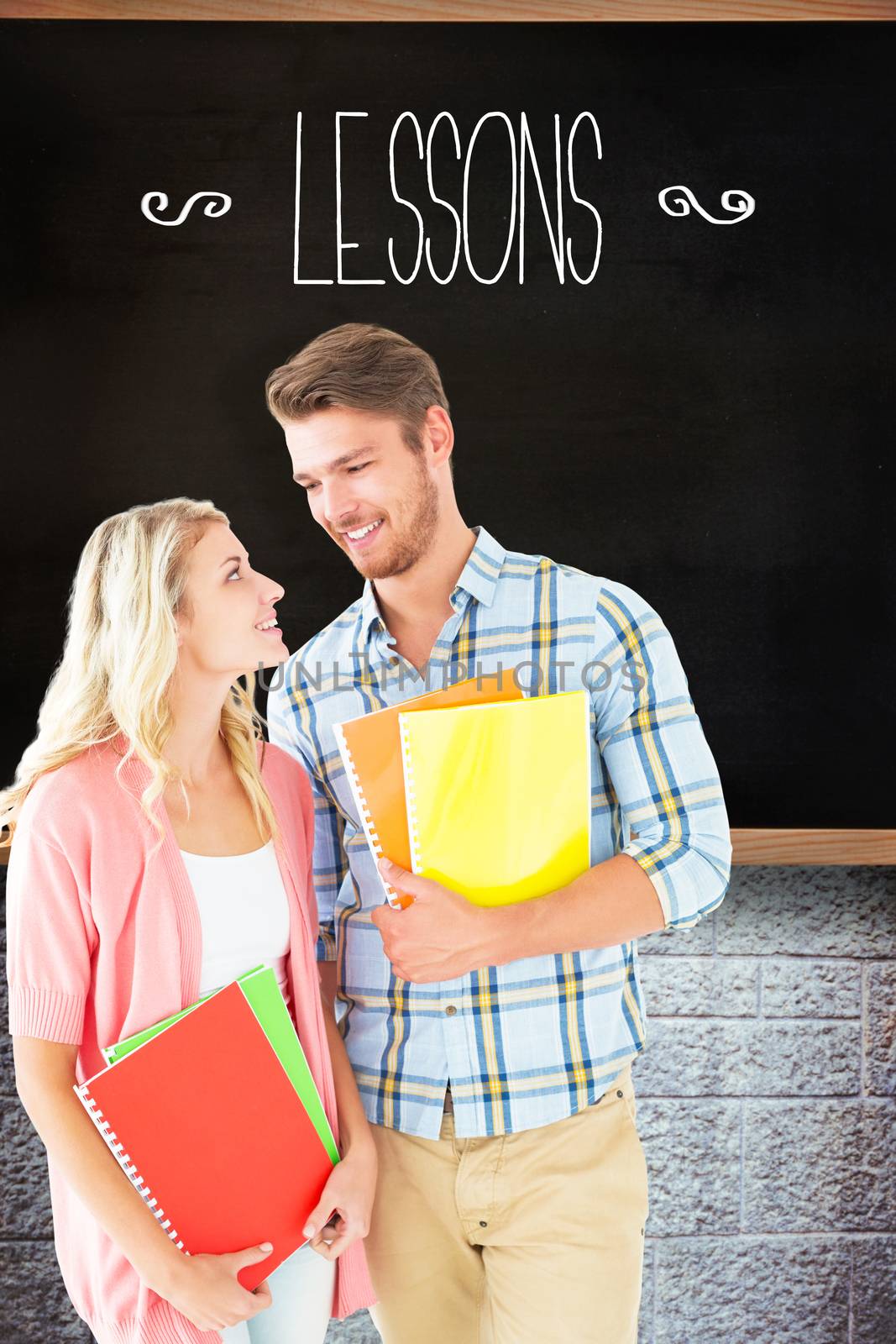 The word lessons and happy students smiling at each other against chalkboard in classroom