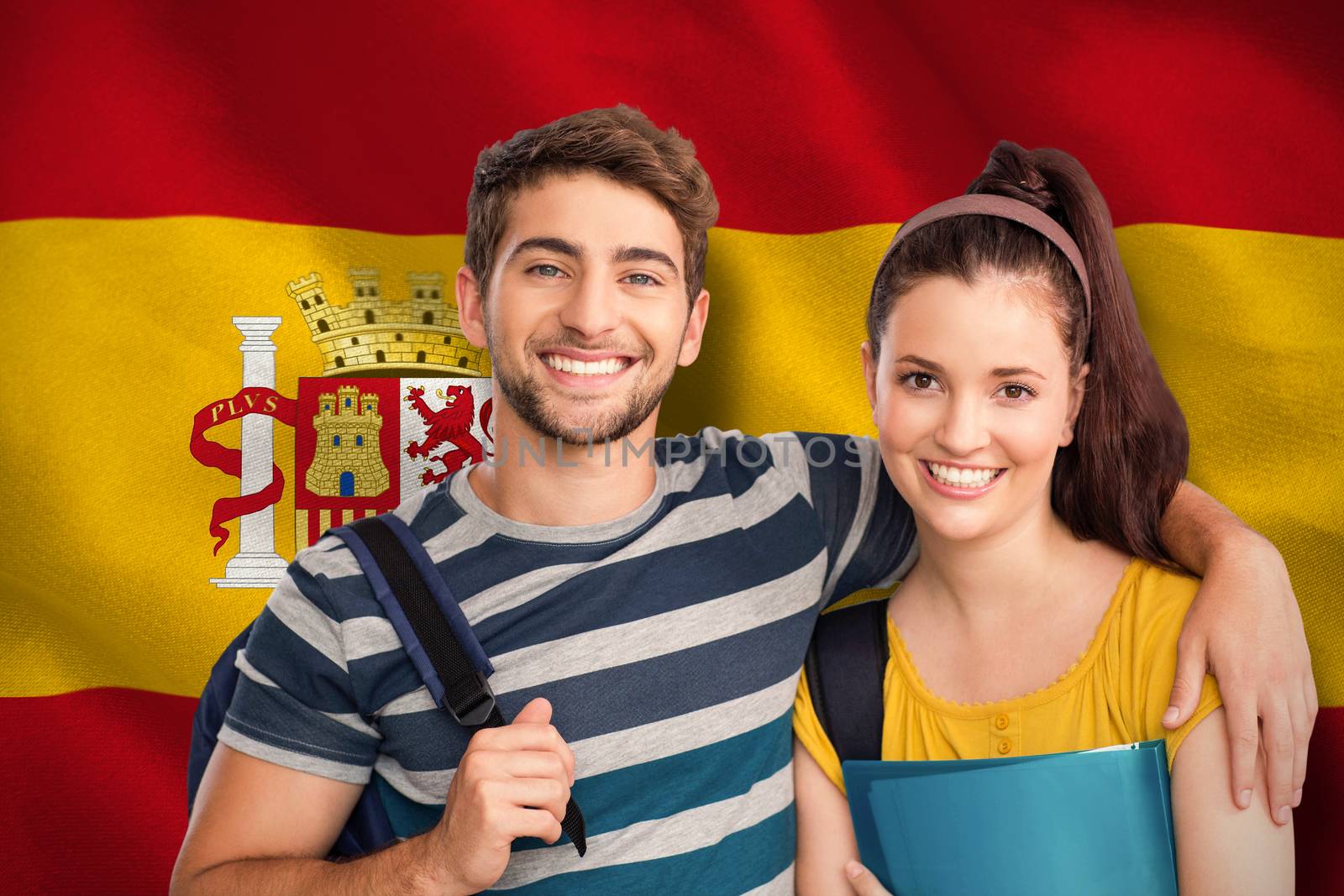 Happy students against digitally generated spanish national flag