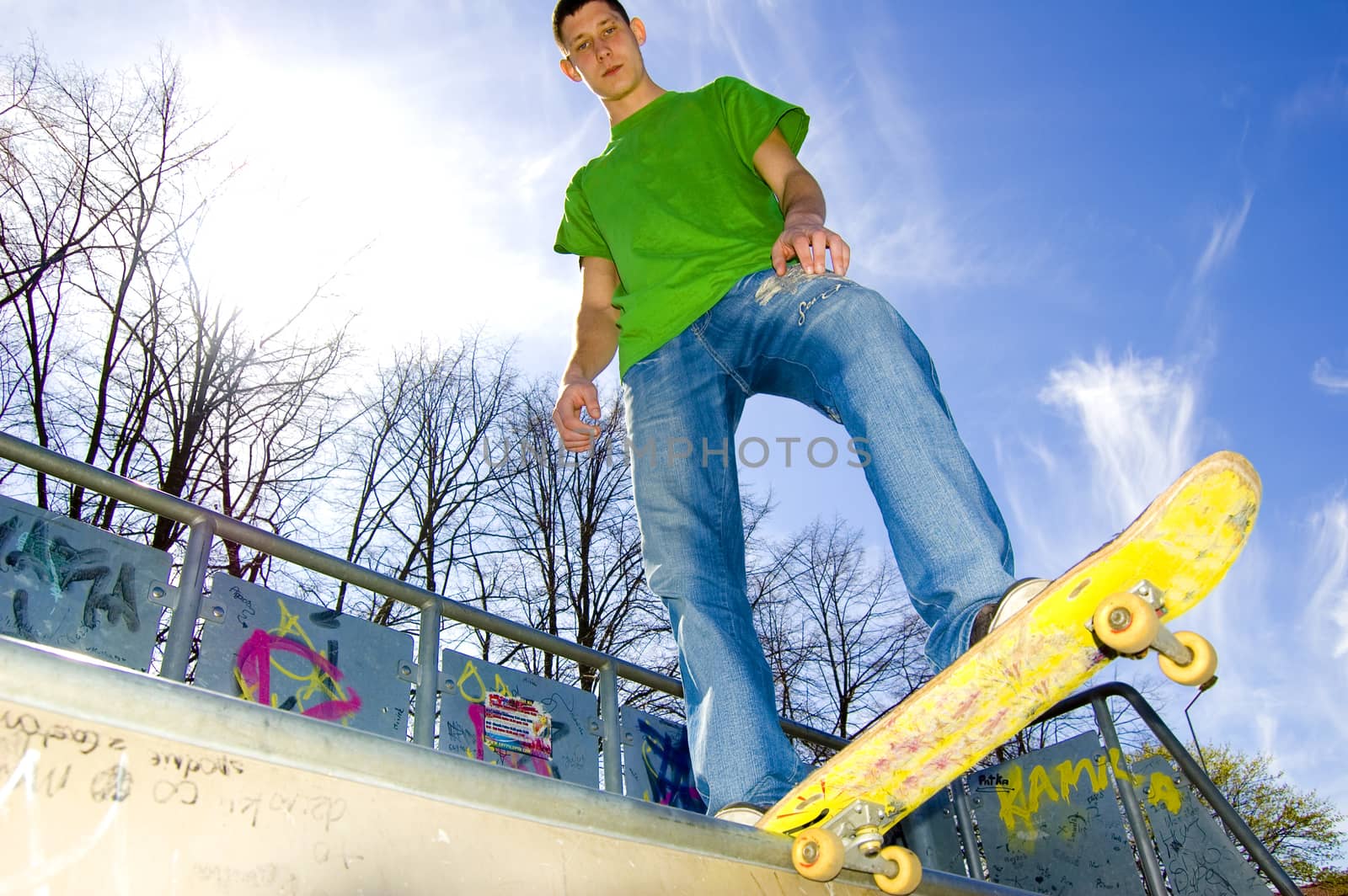 Sport conceptual image.  Teenage skateboarder standing on the ramp with skateboard.