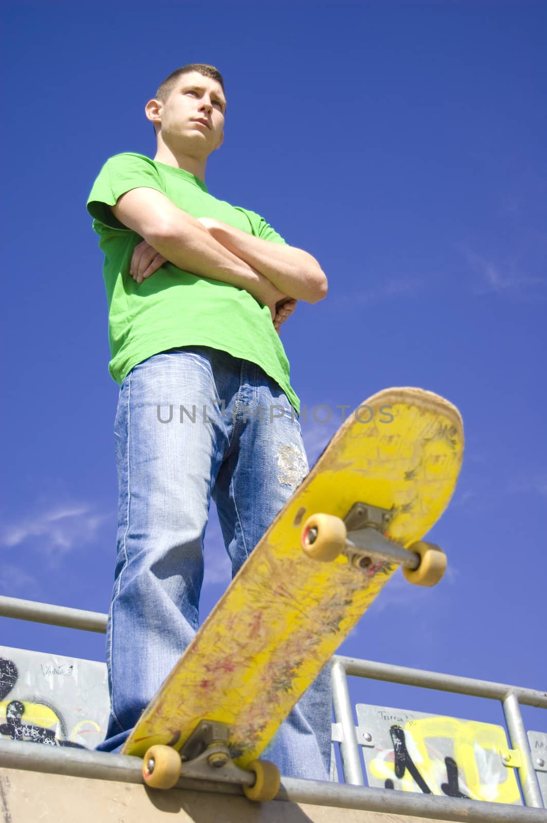 Sport conceptual image.  Teenage skateboarder standing on the ramp with skateboard.