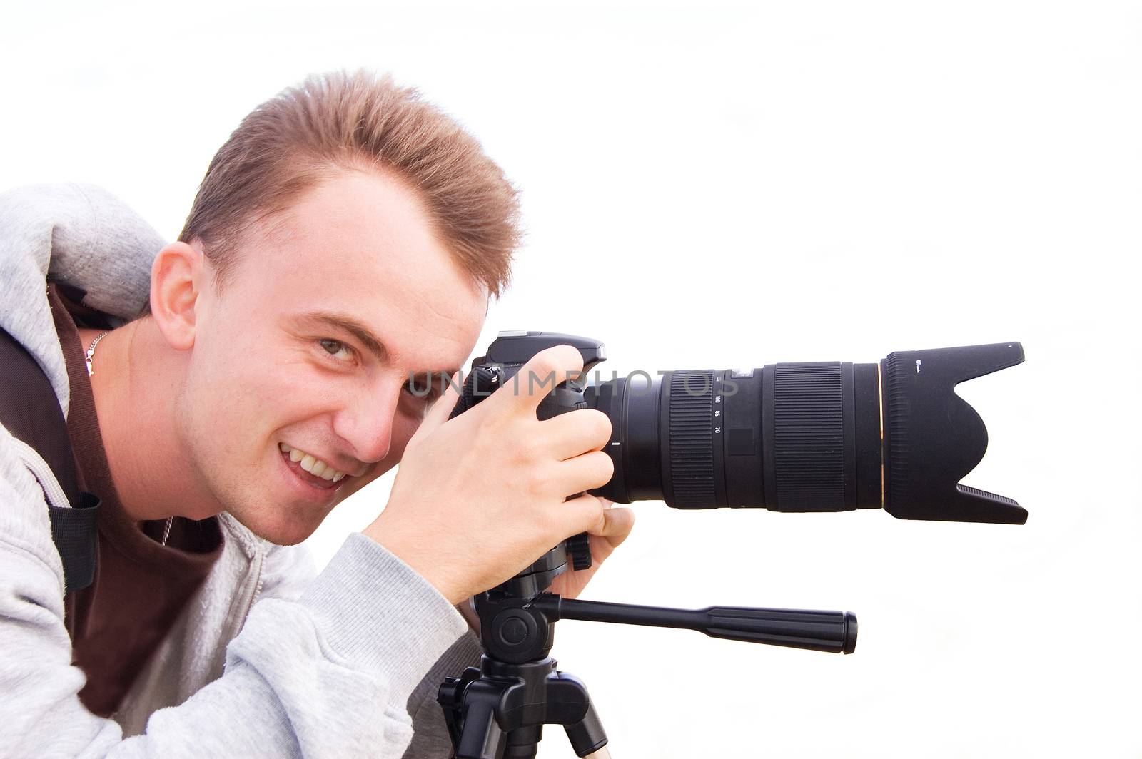 Professional photographer taking pictures and smiling. Isolated picture.