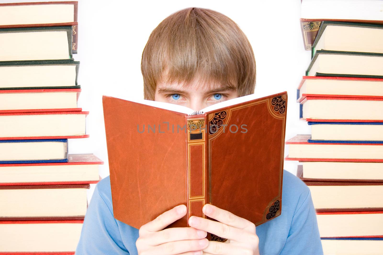 Education conceptual image. Young boy reading and studying between books.