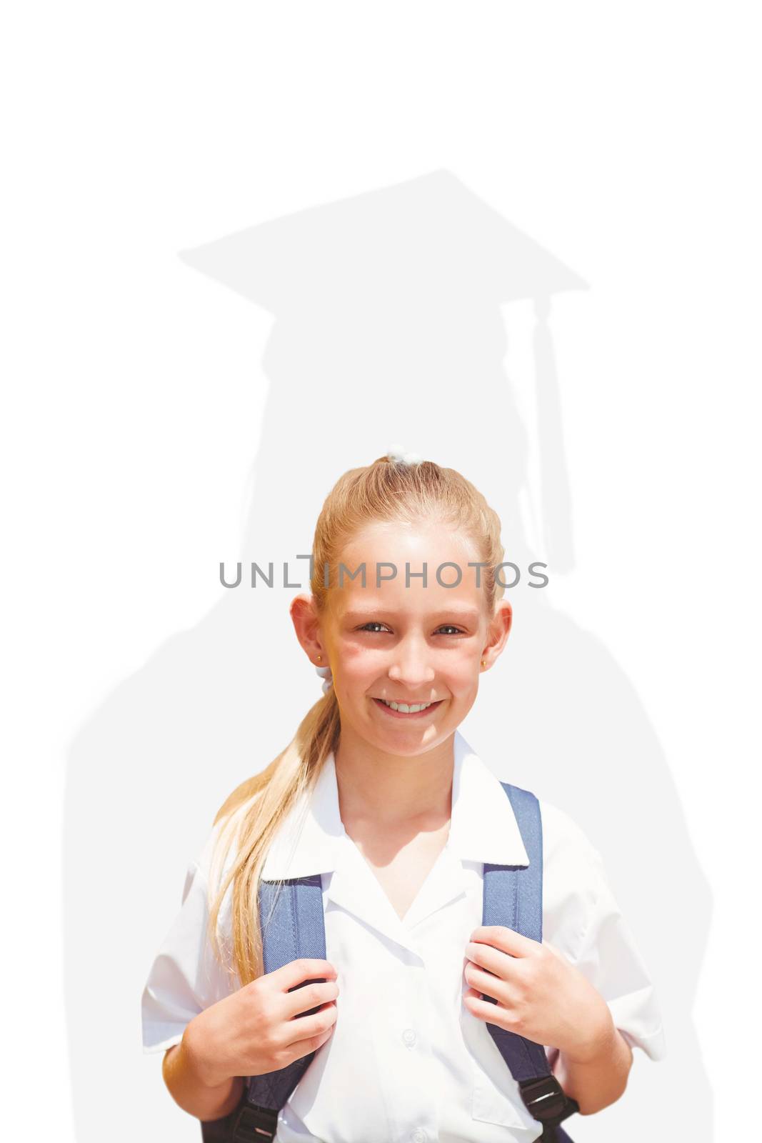 Cute pupil smiling at camera by the school bus against silhouette of graduate
