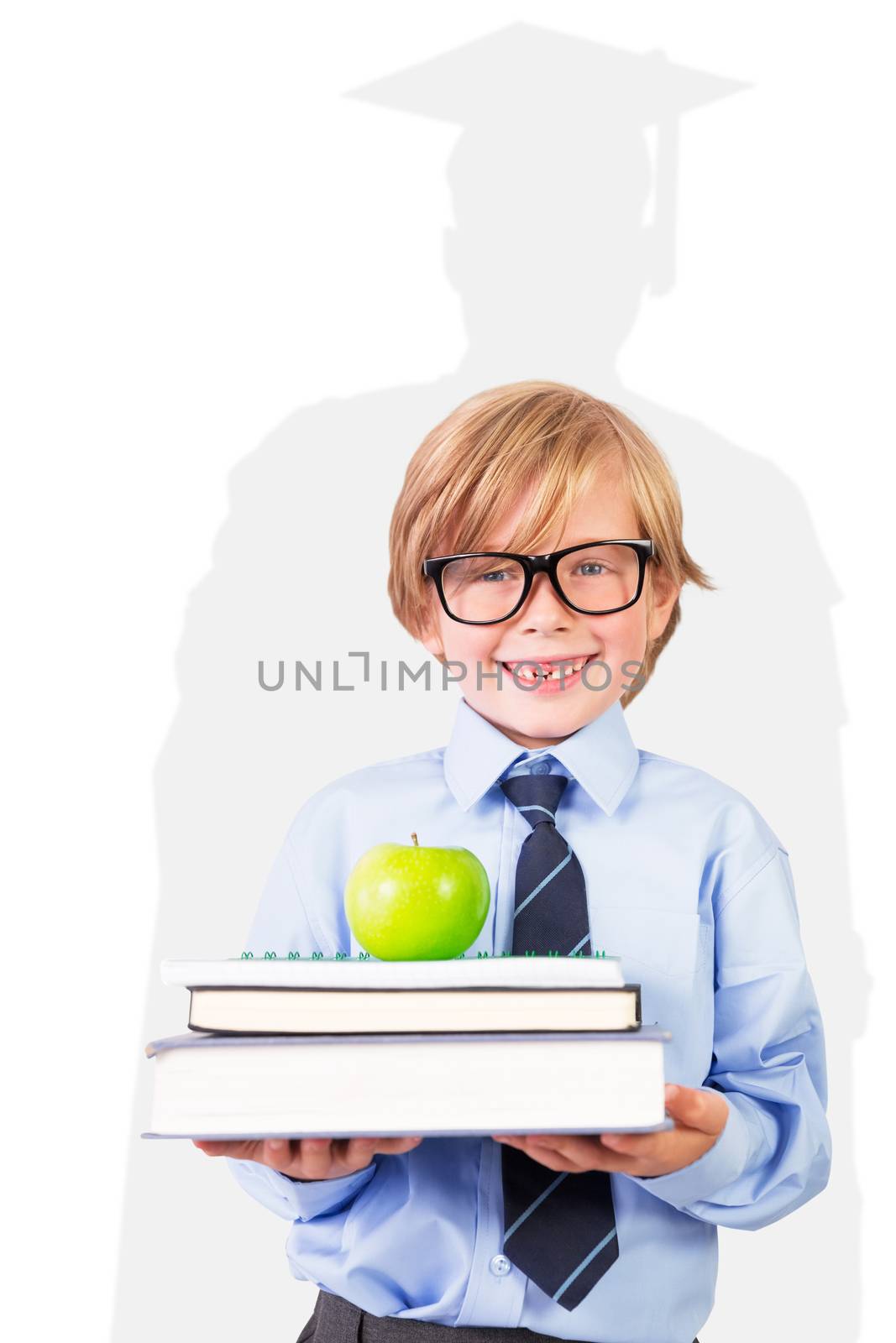 Cute pupil holding books and apple against silhouette of graduate