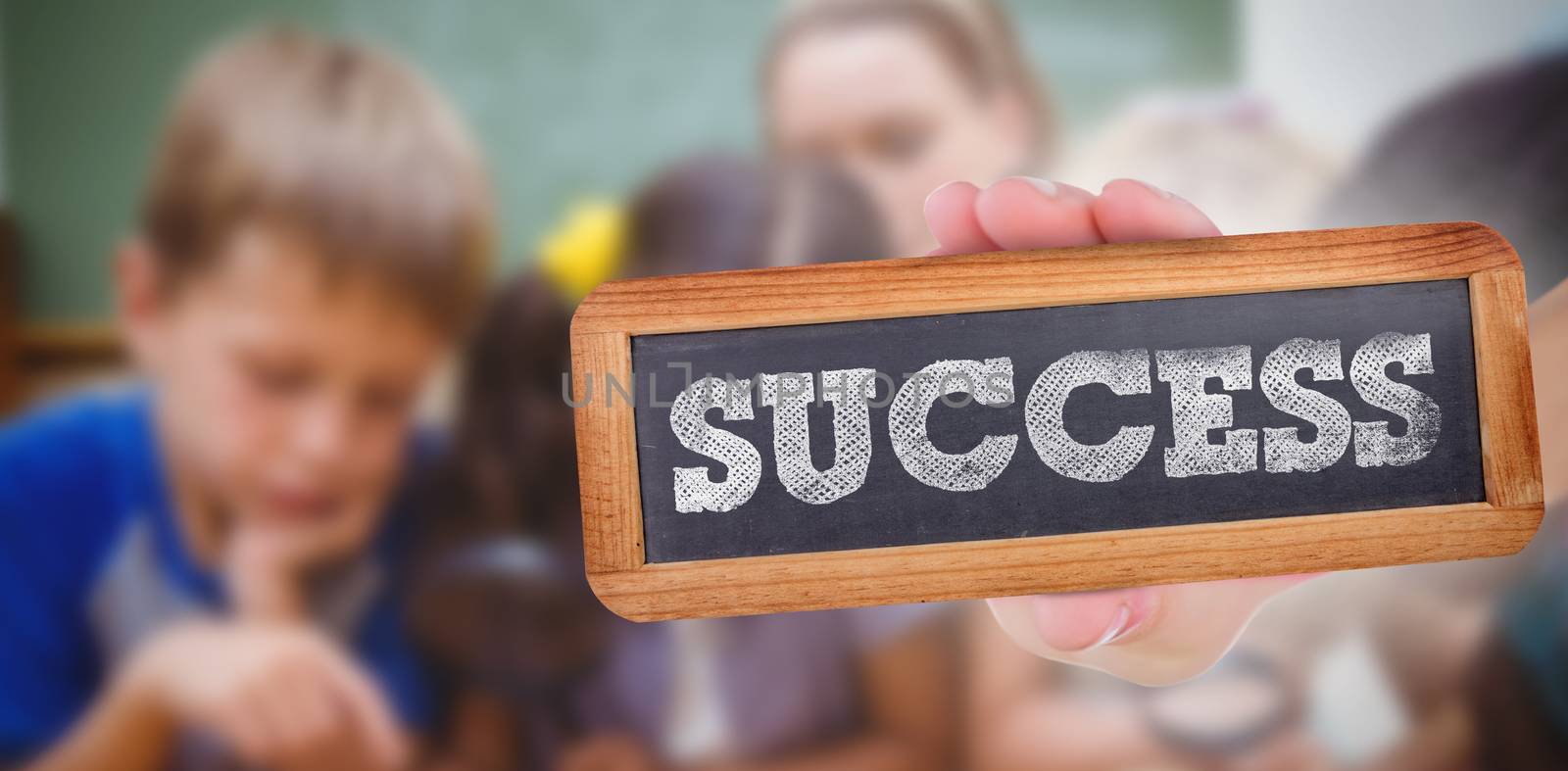 The word success and hand showing chalkboard against cute pupils looking through magnifying glass