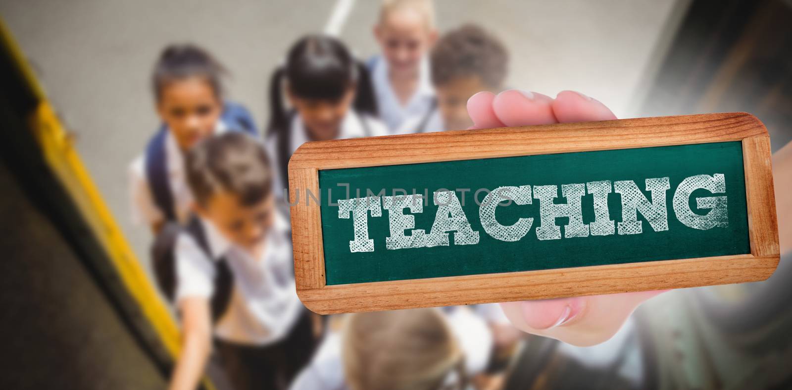 The word teaching and hand showing chalkboard against cute schoolchildren getting on school bus