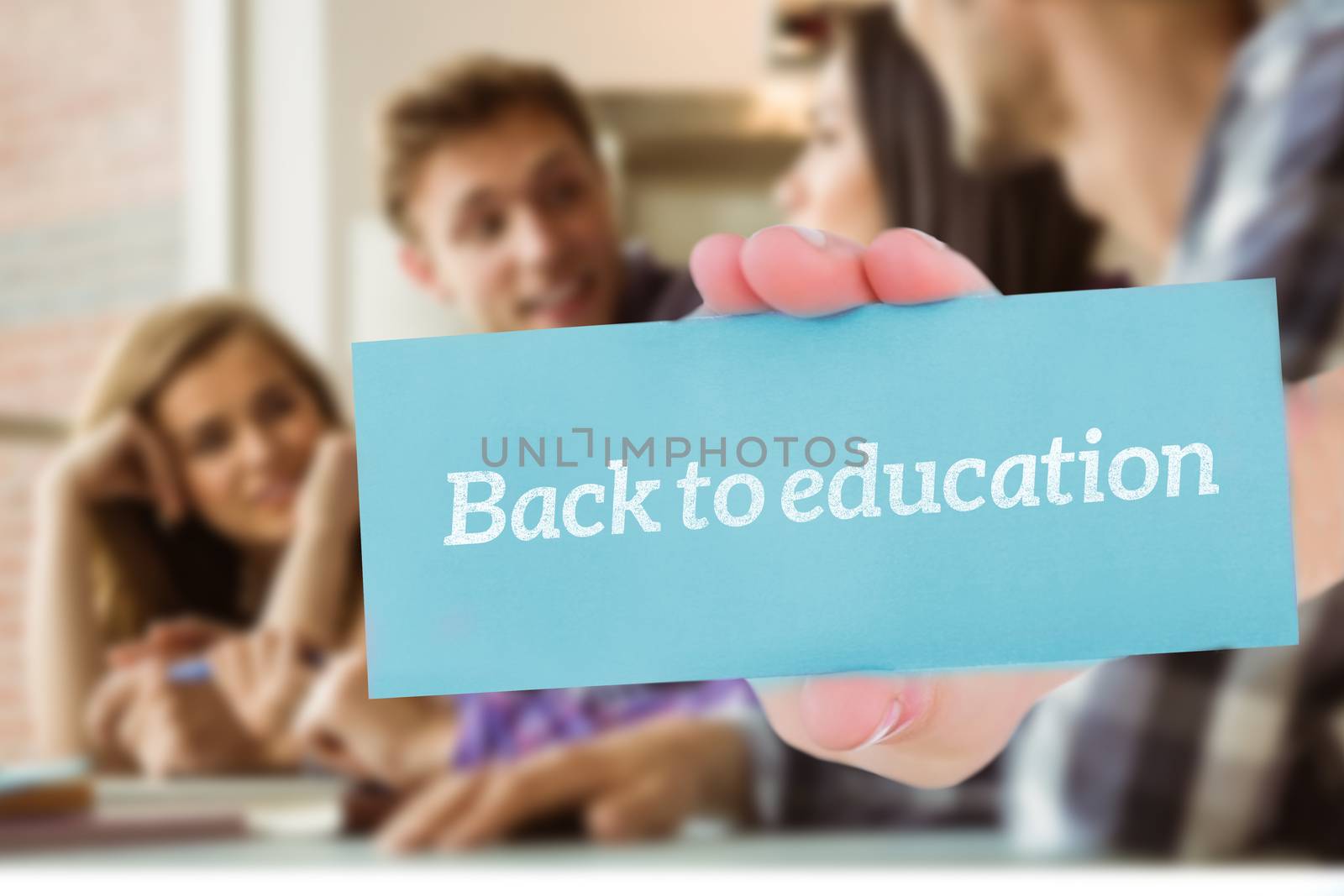 The word back to education and hand showing card against smiling friends students talking together