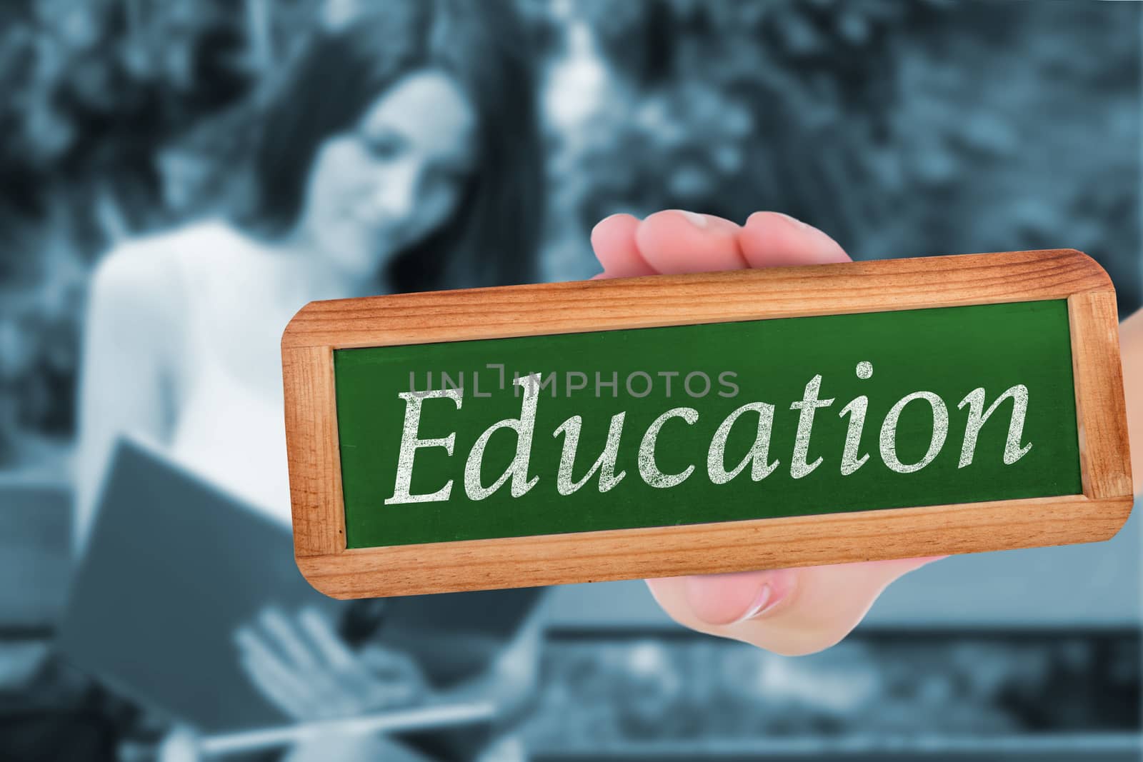 The word education and hand showing chalkboard against pretty student studying outside on campus