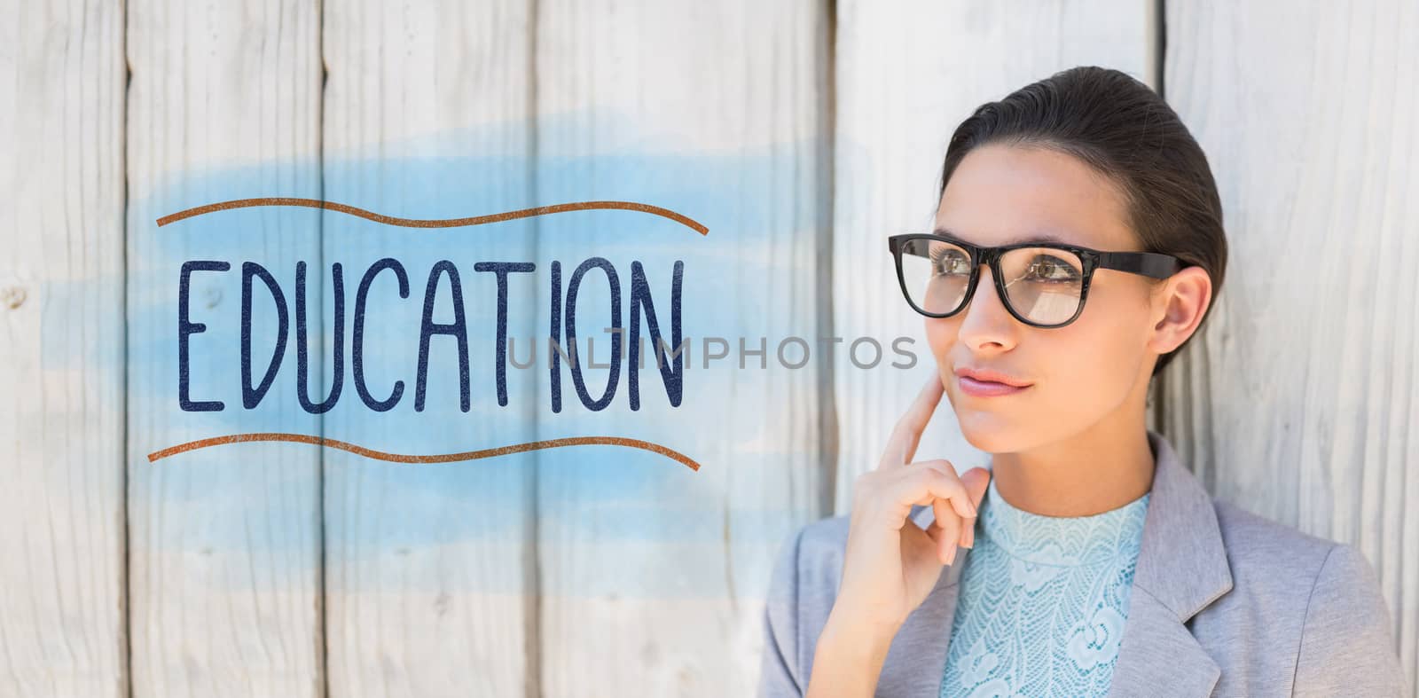 Education against stylish brunette thinking and smiling by Wavebreakmedia