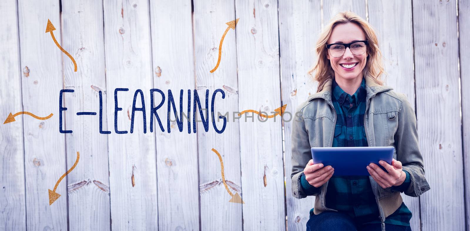 The word e-learning against smiling blonde in glasses using tablet pc