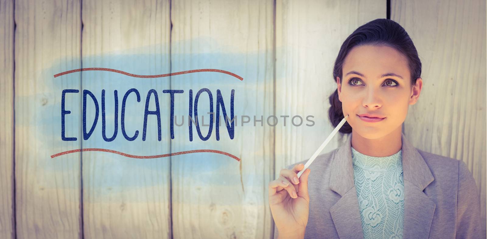 The word education against stylish brunette thinking and smiling