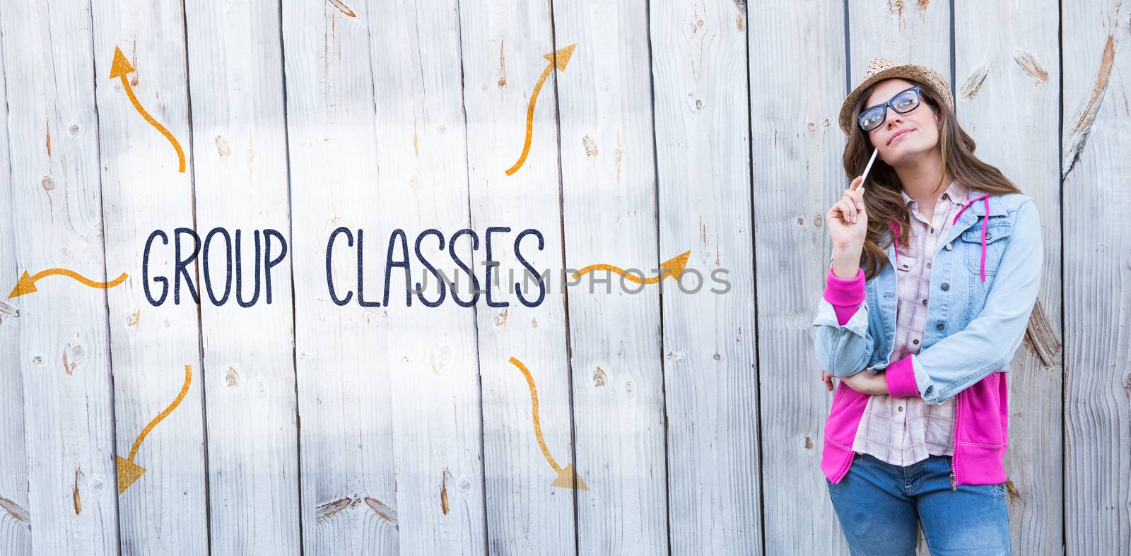 The word group classes against thoughtful woman holding paint brush