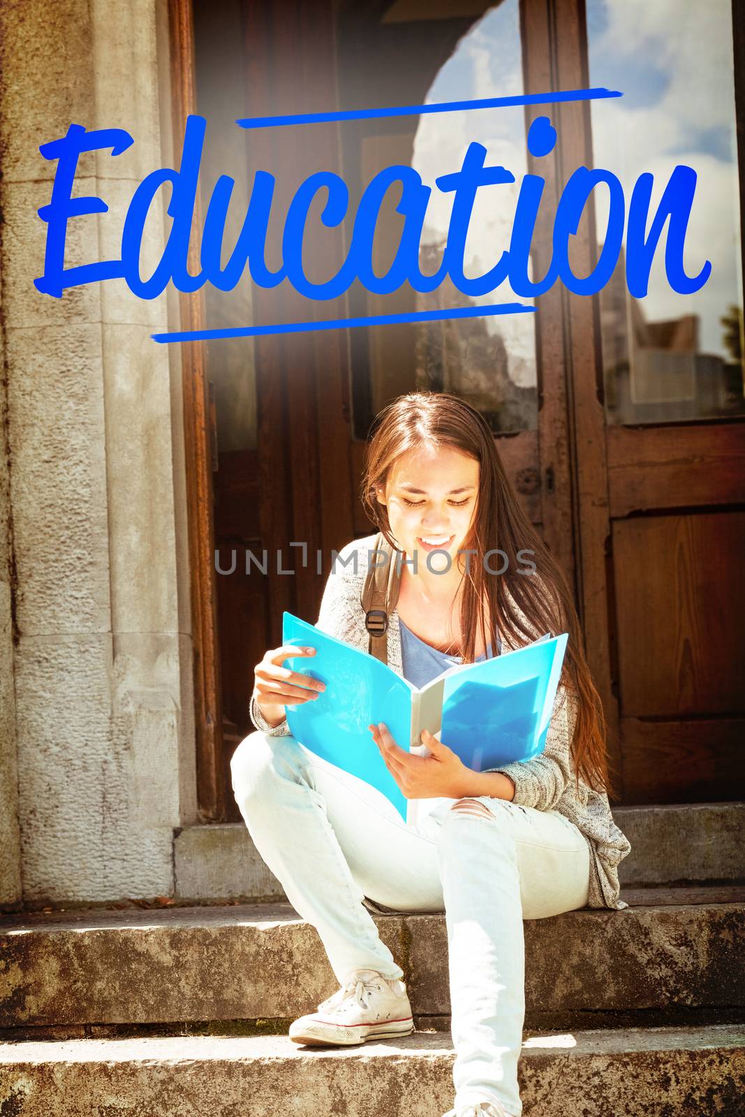 The word education against smiling student sitting and reading book