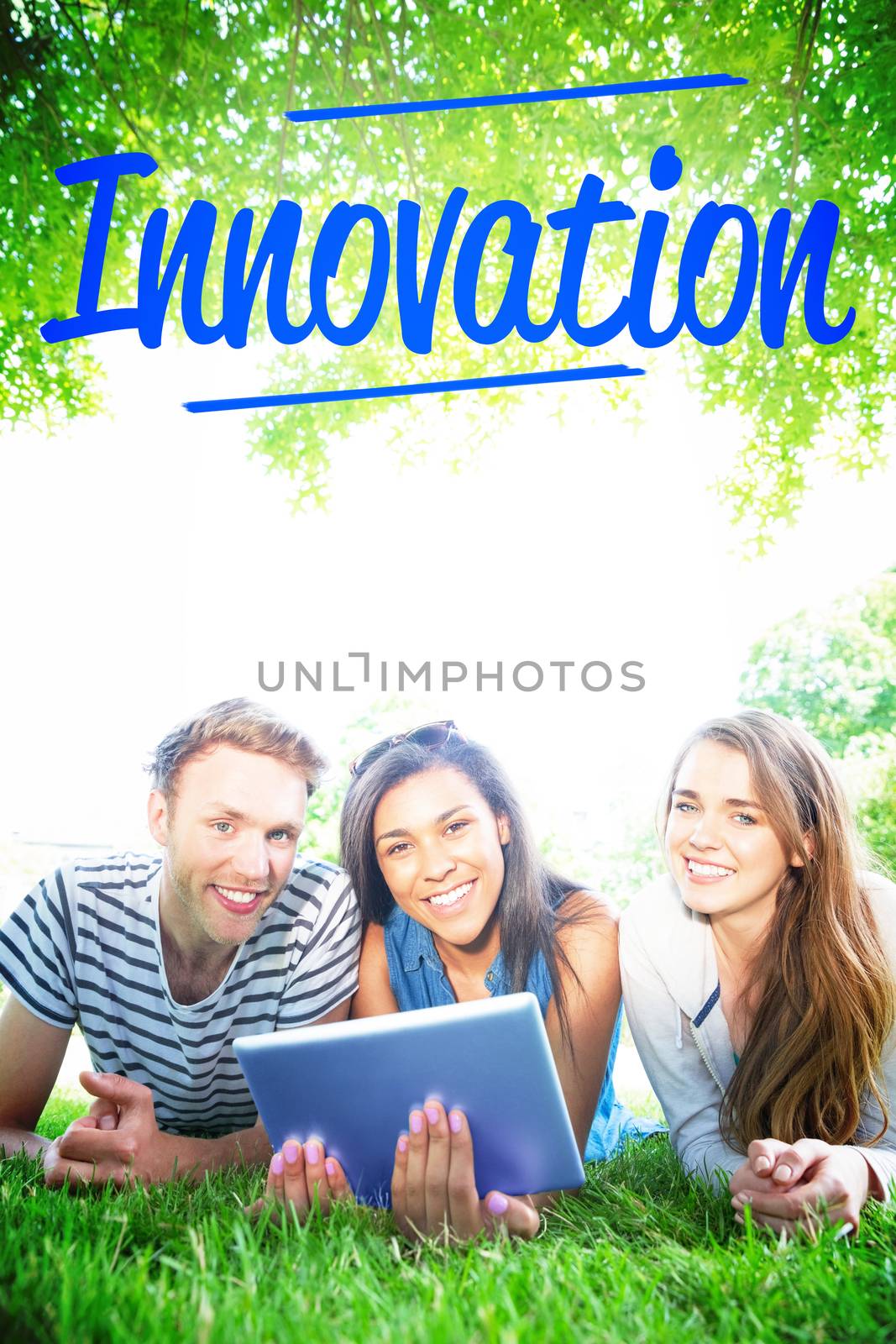 The word innovation against happy students using tablet pc outside
