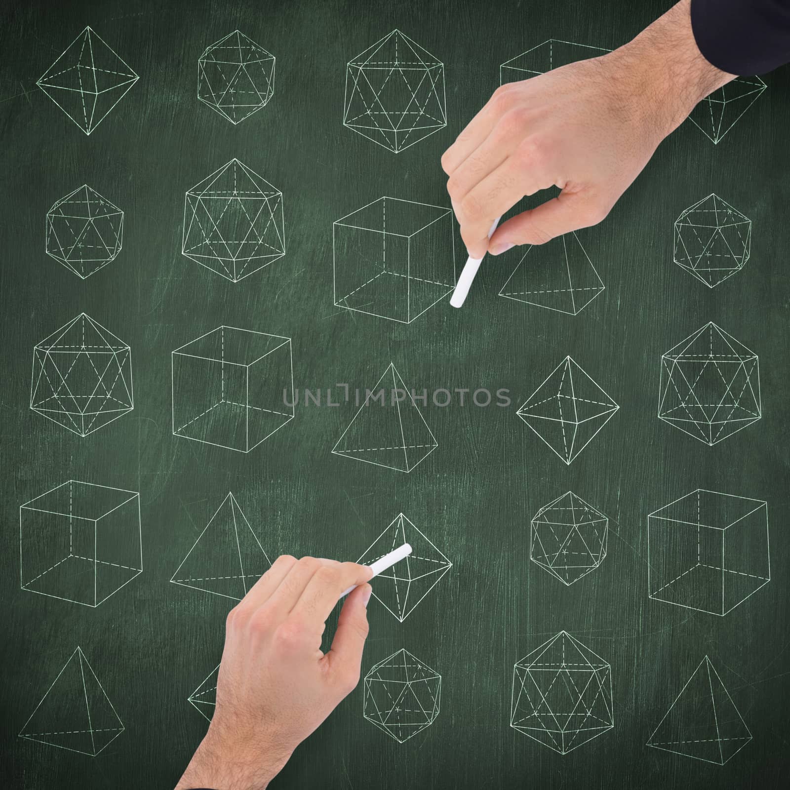 Hand of a businessman writing with a white chalk against green chalkboard