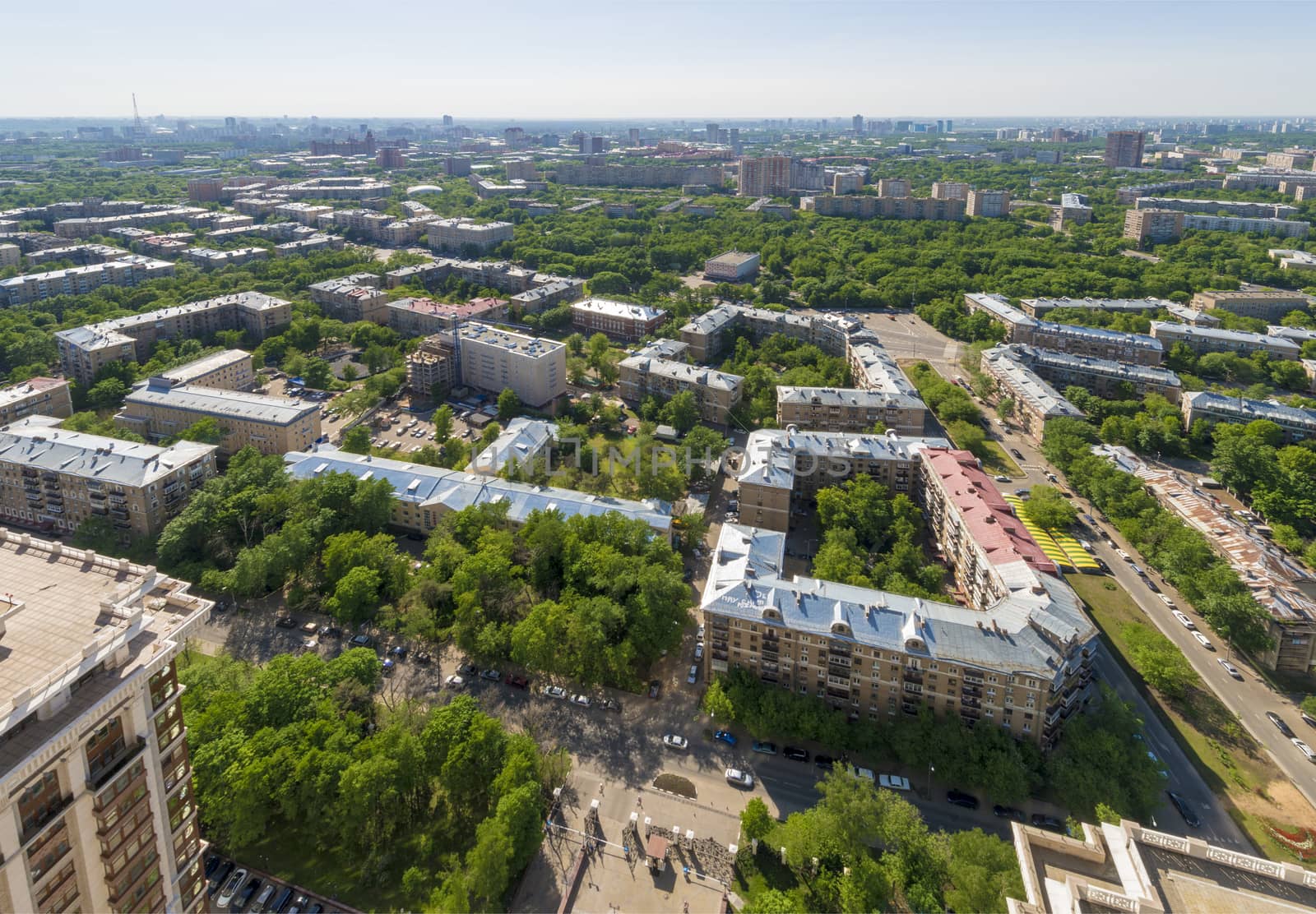 View of Moscow modern residential quarters at sunset on top of the roof of a tall building