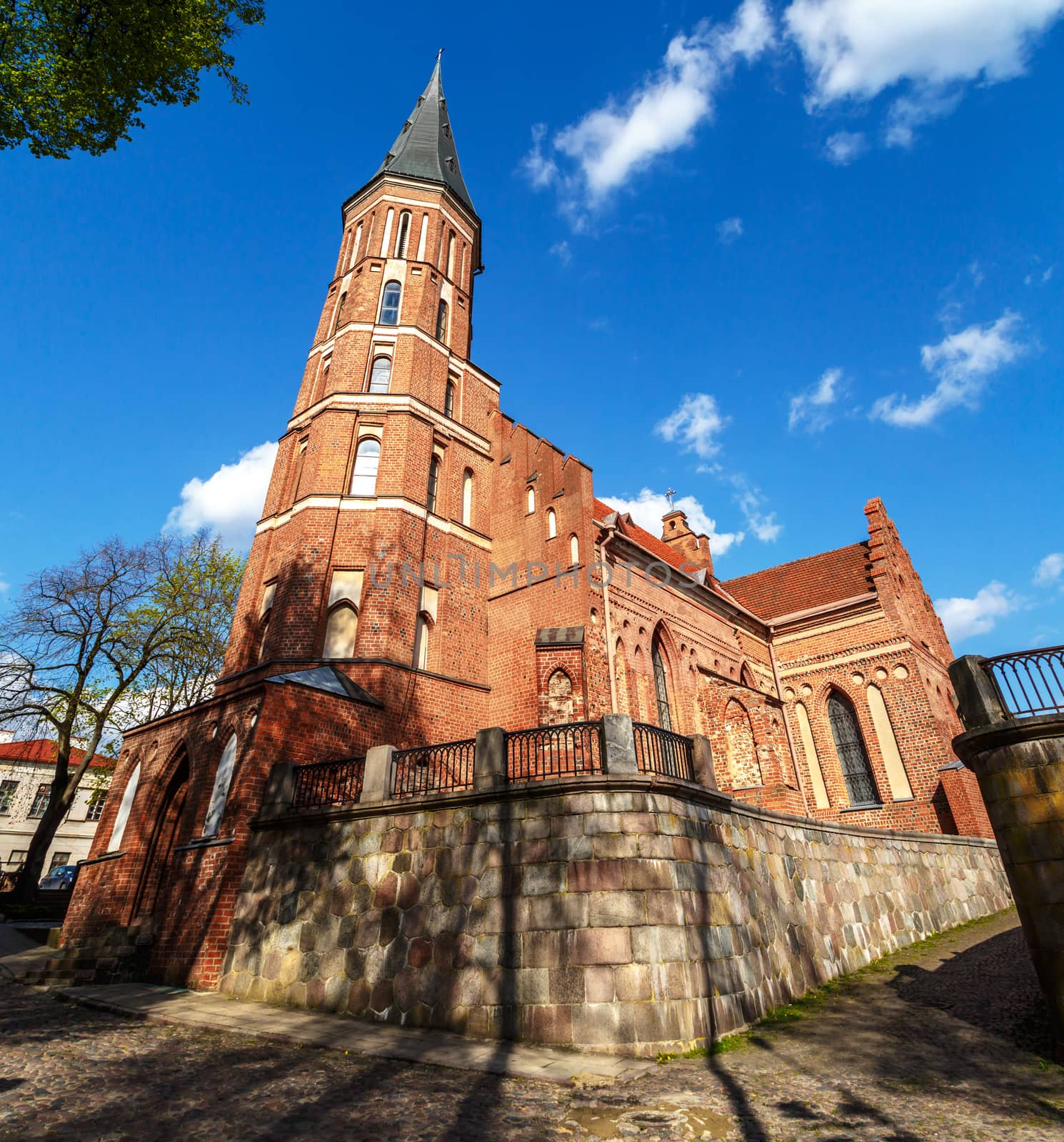 Bottom view of the roman catholic church named Vytatuas' Great Church of the Assumption of the Holy Virgin Mary, on cloudy blue sky background.
