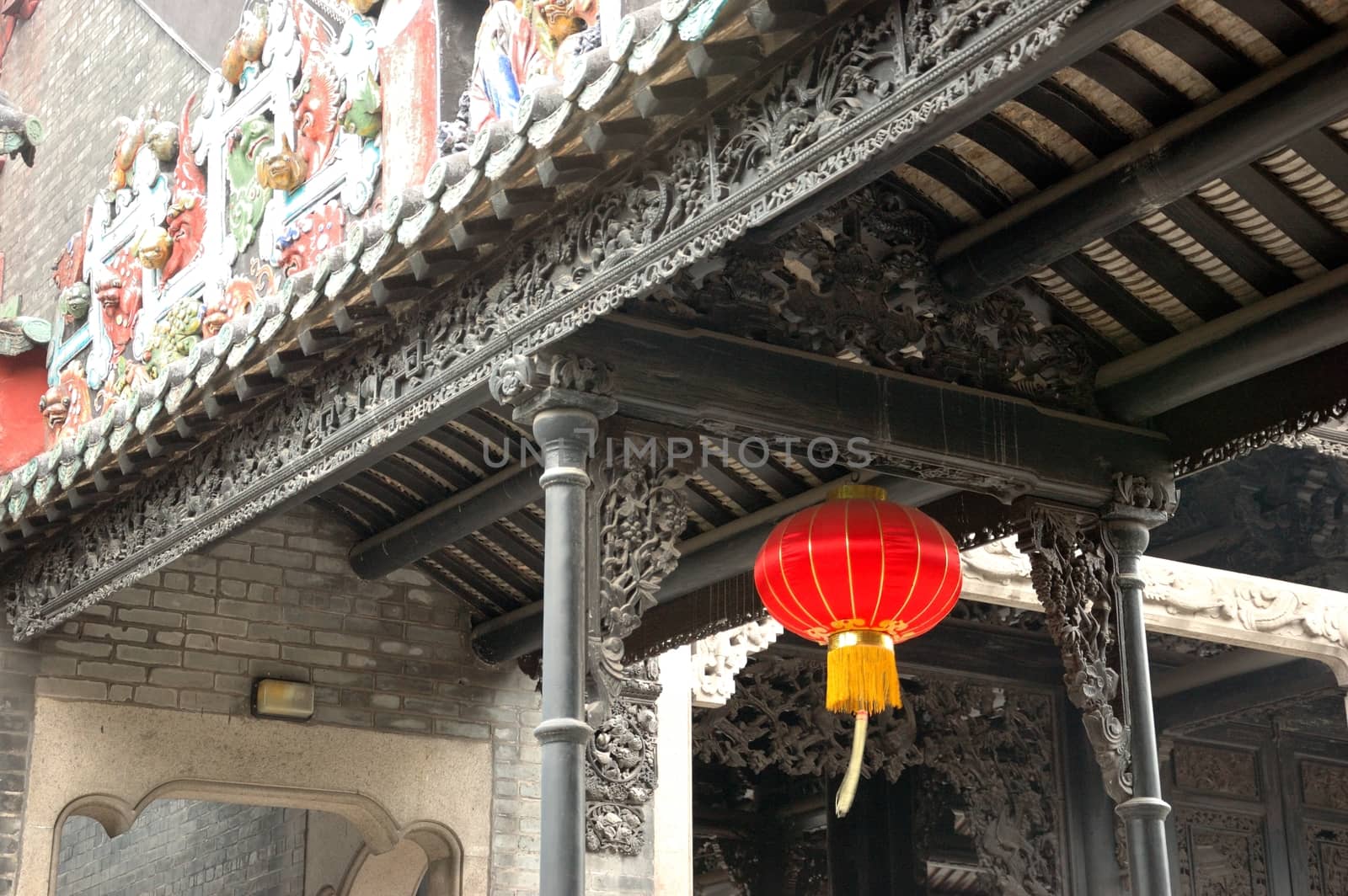 Historical roofs inside Chen Family Temple in Guangzhou, China. Roofs and colums with colorful decorations.