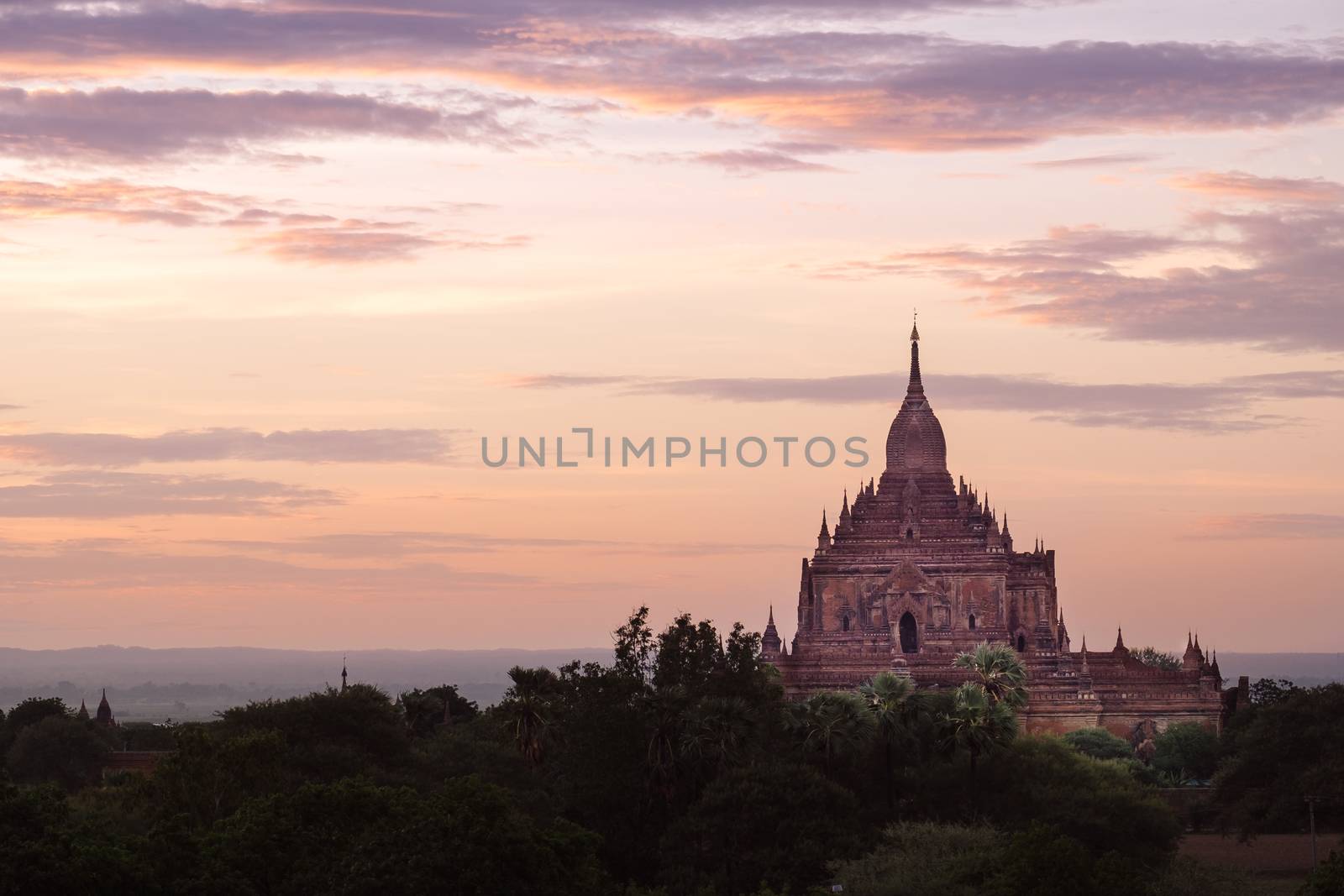 Scenic colorful sunset of ancient temple in Bagan with dramatic clouds, Myanmar