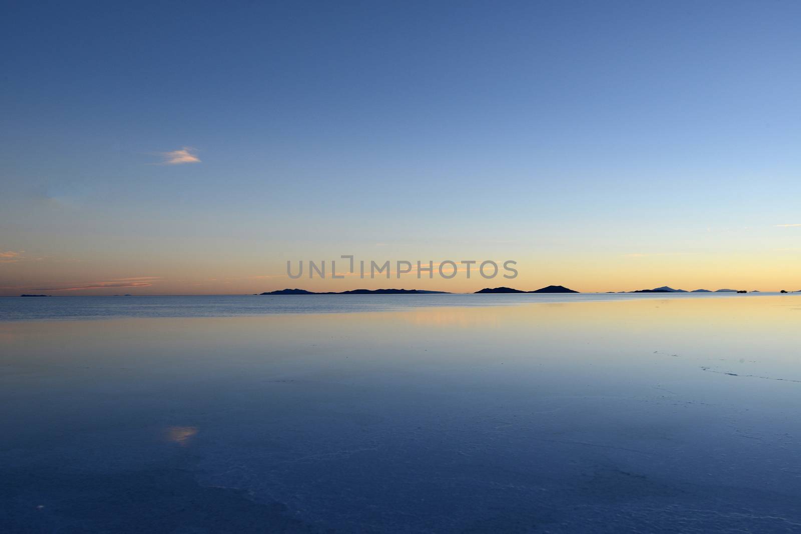 reflection over a pond in uyuni salt flat in bolivia