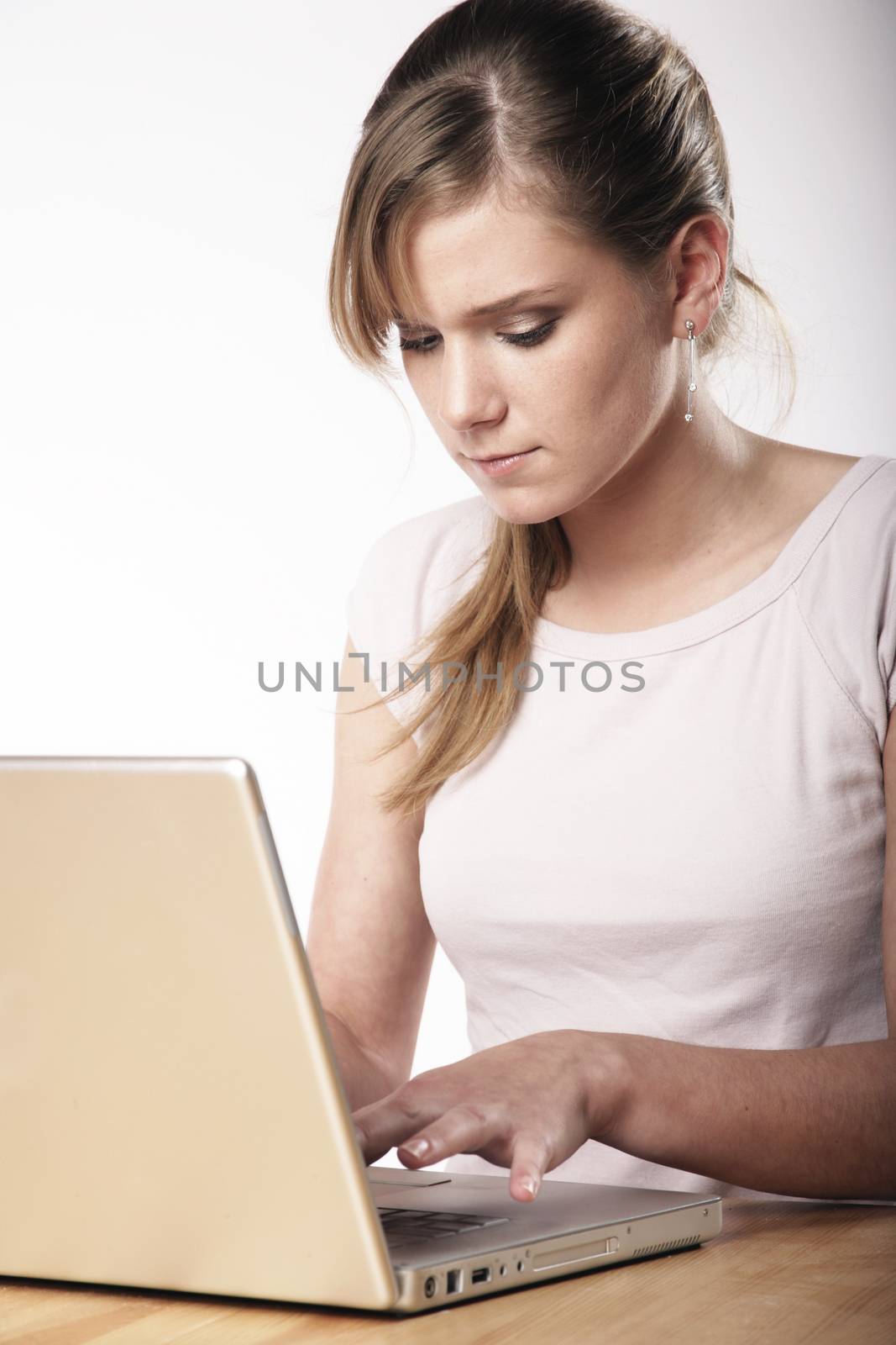 Young woman sitting at a table in front of her computer