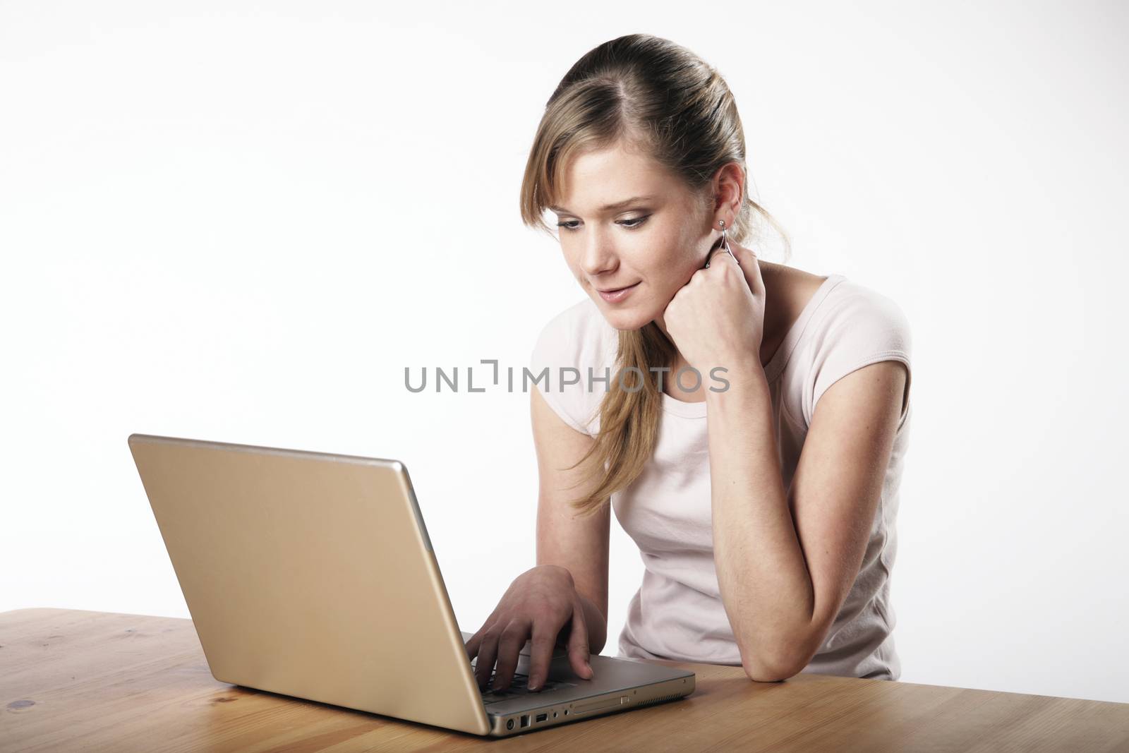 Young woman sitting at a table in front of her computer