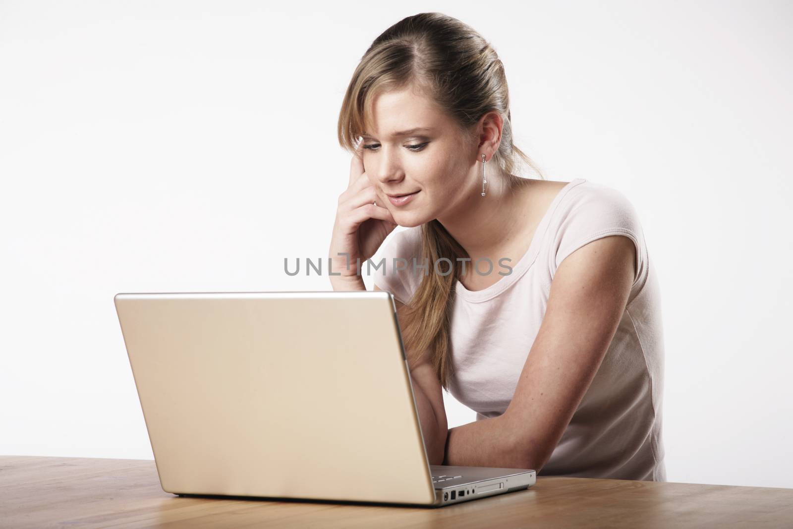 Young woman sitting at a table in front of her computer