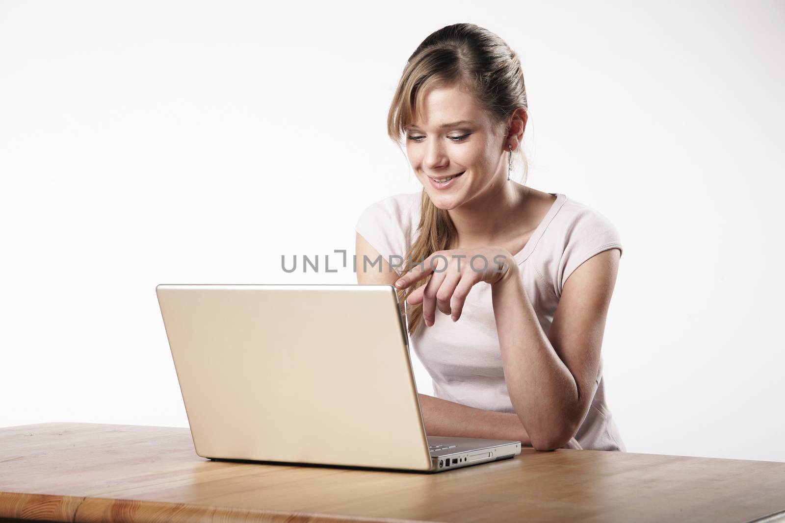 Young woman sitting at a table in front of her computer